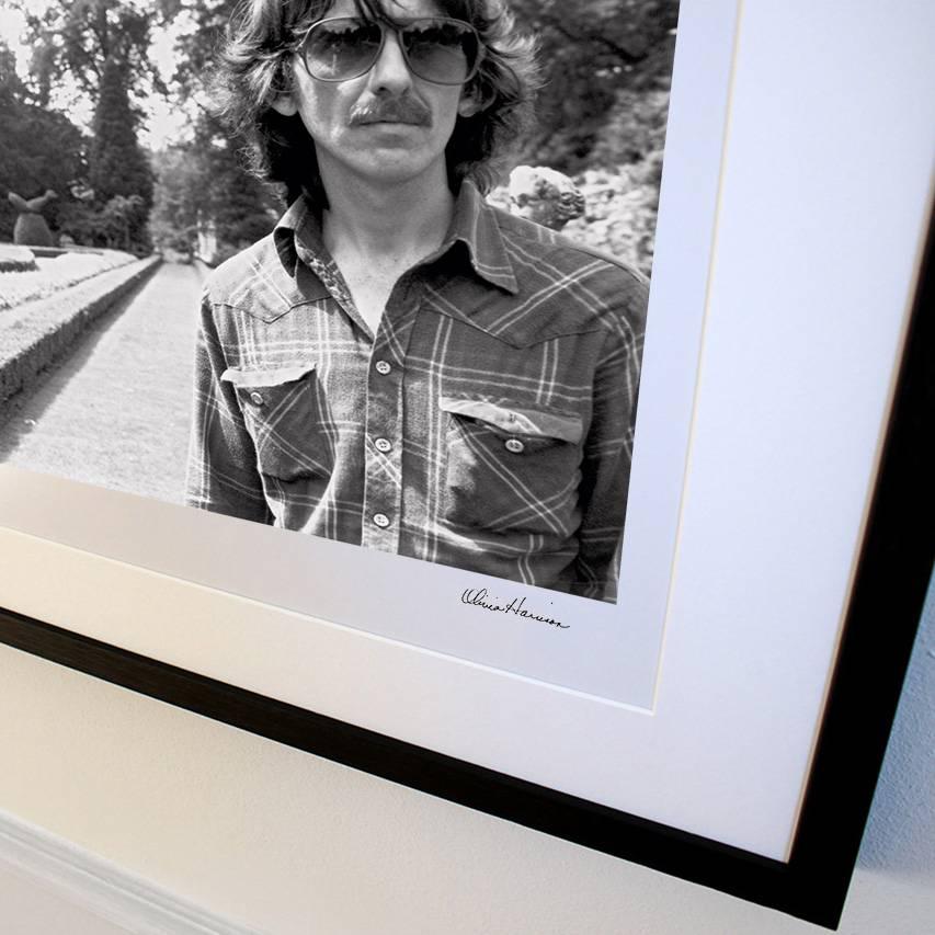 I'm a gardener. I plant flowers and watch them grow. – George Harrison

'George in the gardens at Cliveden House' presents an informal black and white landscape portrait of the Beatles member and keen amateur gardener on a visit to the stately