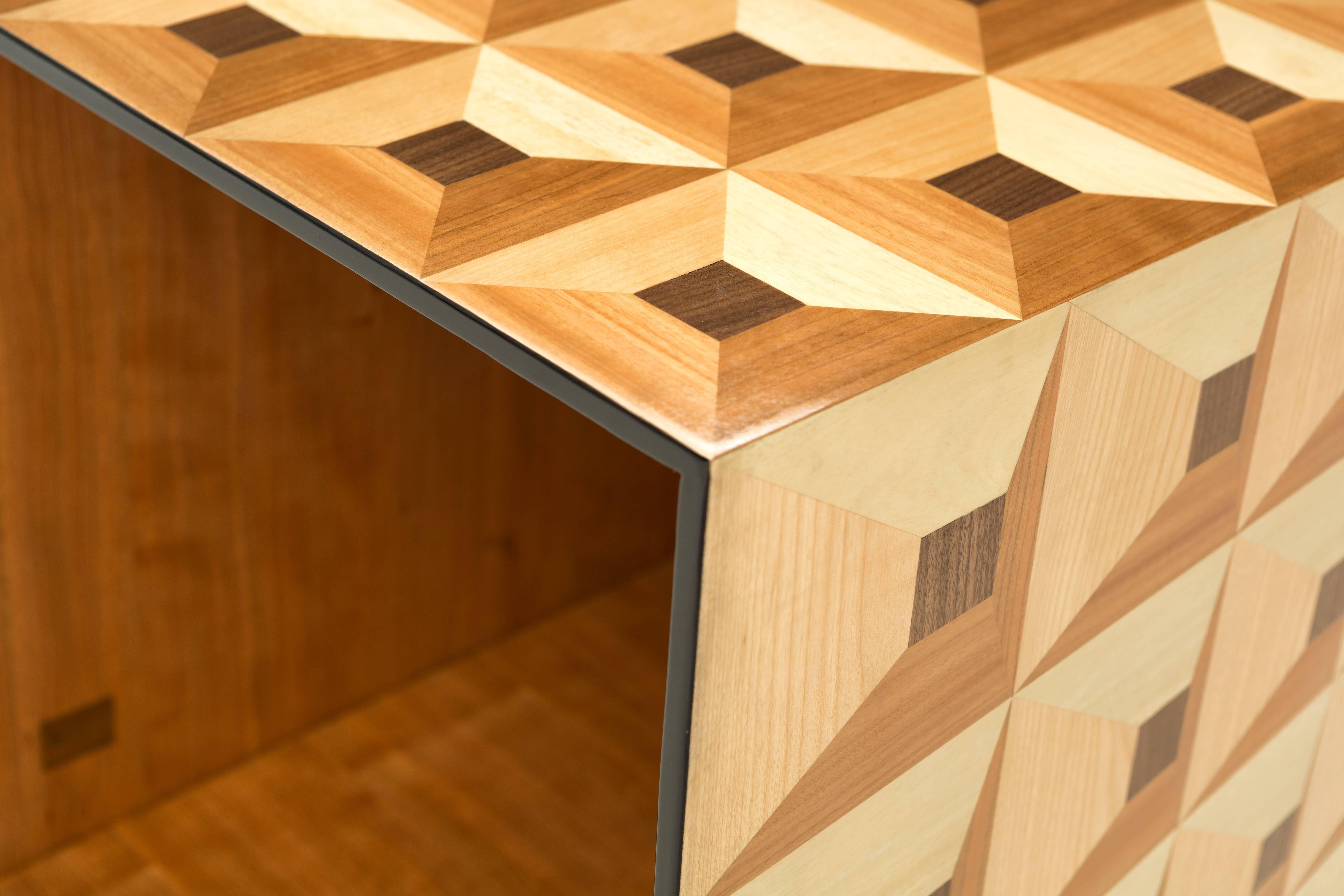 This unusual wooden cube part of the ‘Moonlight’ collection, covered in magnificent wood marquetry geometric trompe‐l’oeil is a wonderful example of versatility and storage possibilities. Used as a single piece it becomes a side table, used by two