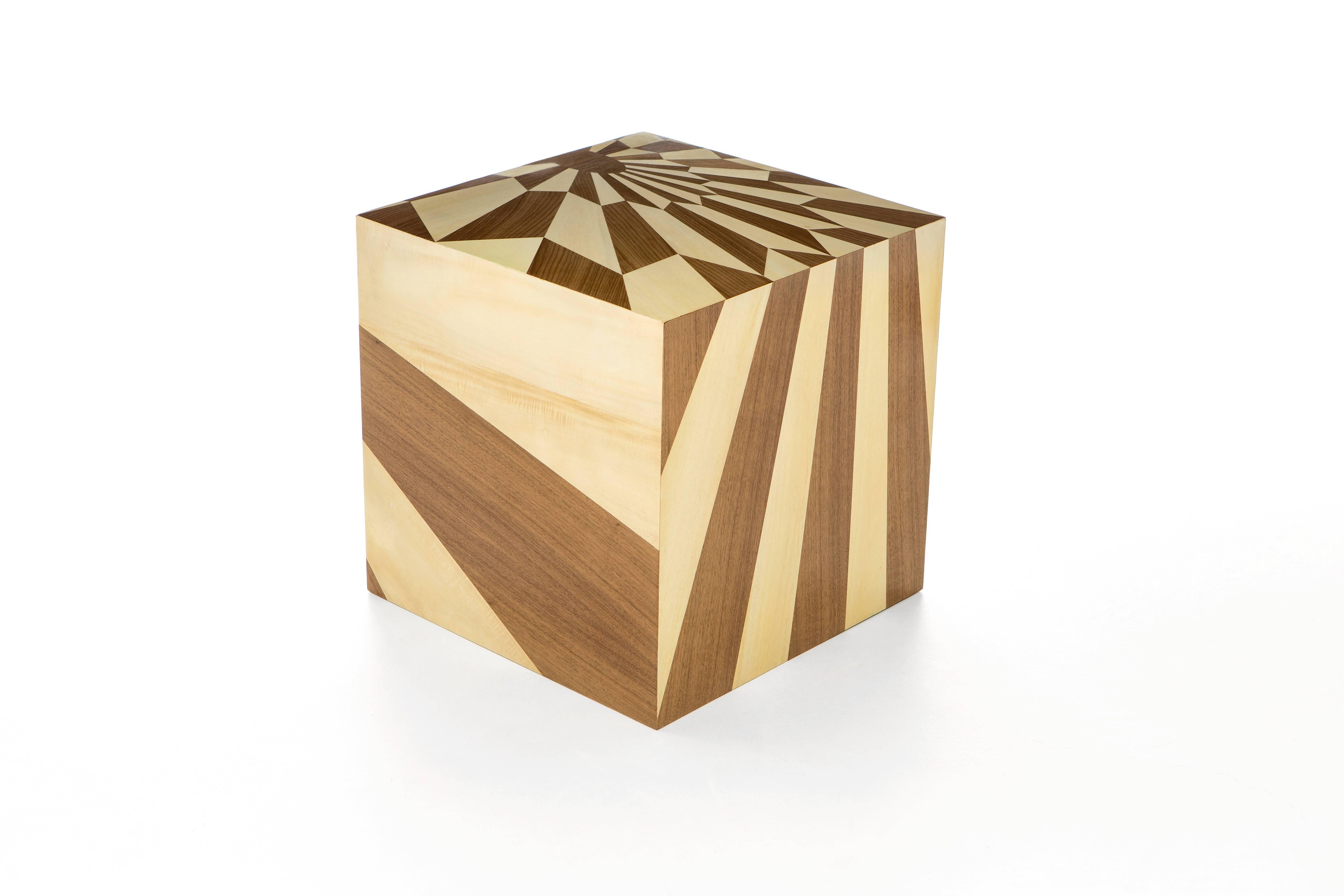 The tectonic silence cube, an unusual & dynamic piece of furniture, is covered in magnificent wood marquetry geometric pattern is a wonderful example of versatility and storage possibilities. This noble technique consists of hand-cutting perfectly