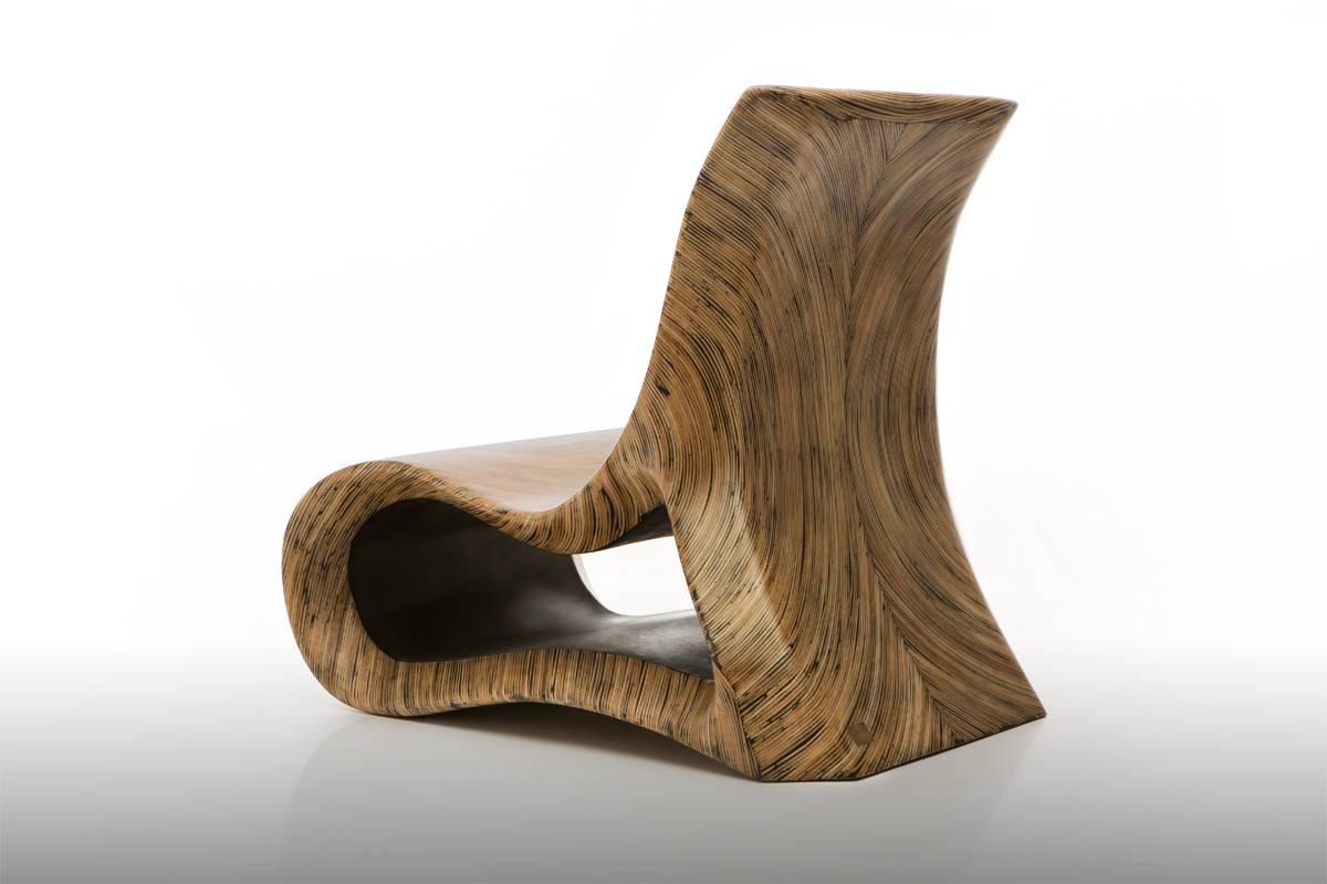The Altoum chair is a mesmerizing piece of furniture, with its meandering curves and seemingly endless tree rings. The shape of this seat takes inspiration from Op Art whilst the sophisticated wood inlay finish breathes life into it. Unique