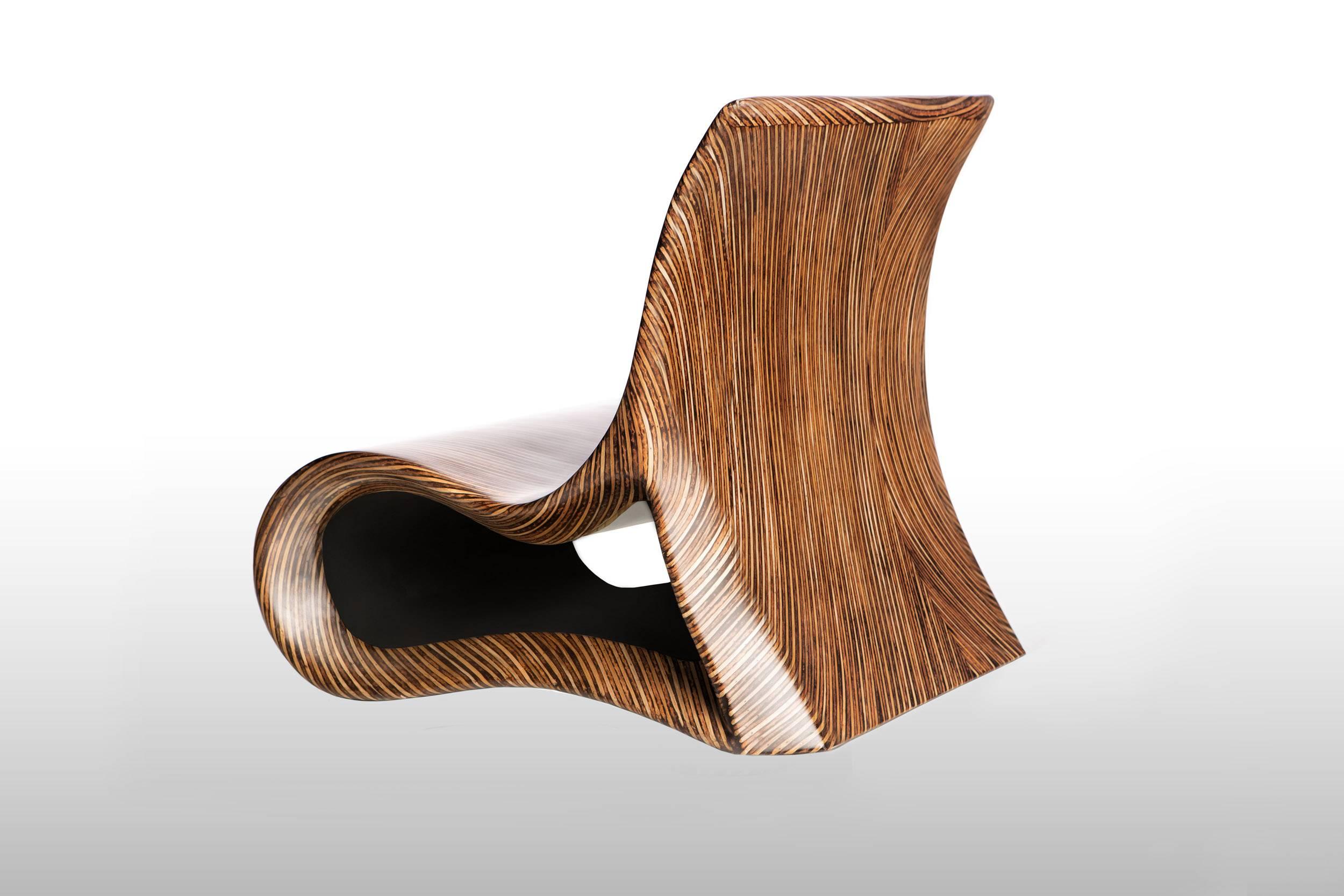 The Altoum chair is a mesmerizing piece of furniture, with its meandering curves and seemingly endless tree rings. The shape of this seat takes inspiration from Op Art whilst the sophisticated wood inlay finish breathes life into it. Available in