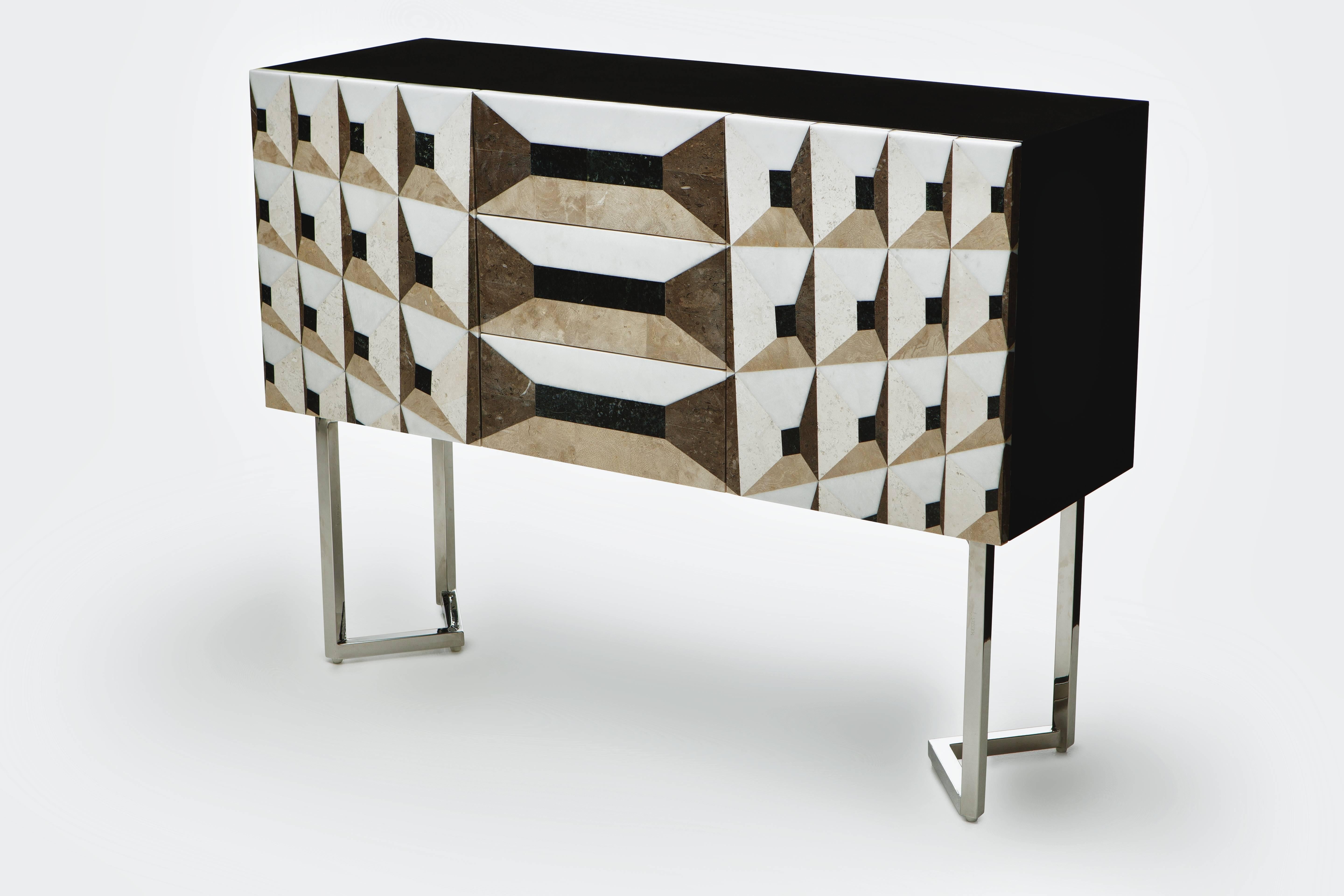 The Midnight gallery sideboard is part of the ‘Moonlight’ collection and enjoys a façade of pure, chiselled lines, acute angles and raw clarity. The geometric trompe-l’oeil executed in noble marble marquetry technique, comprehensive perspective and