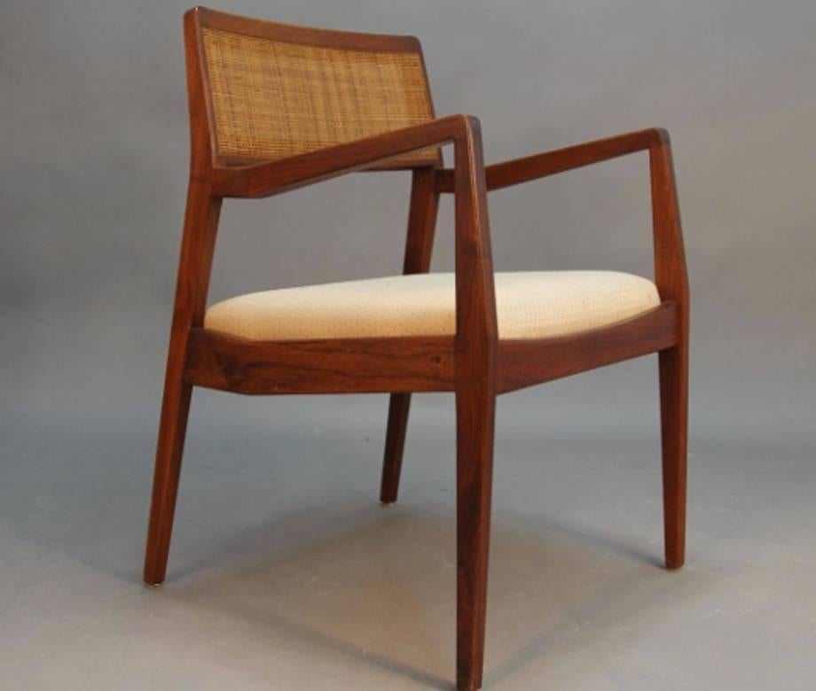 Early 1950s original Jens Risom caned dining chairs and armchairs set, two armchairs and six side chairs.
Warm deep massive walnut wood with original caned backs, a very nice patina. 
This set could match very well with our oversized dining table,