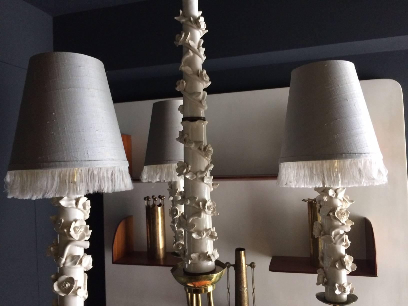 Very chic and unique ceramic chandelier with very beautiful patina brass structure and pale grey silk shades with franges that I created myself.
This piece has never been seen, I found it with a pair of sconces (sold)
The chandelier is really