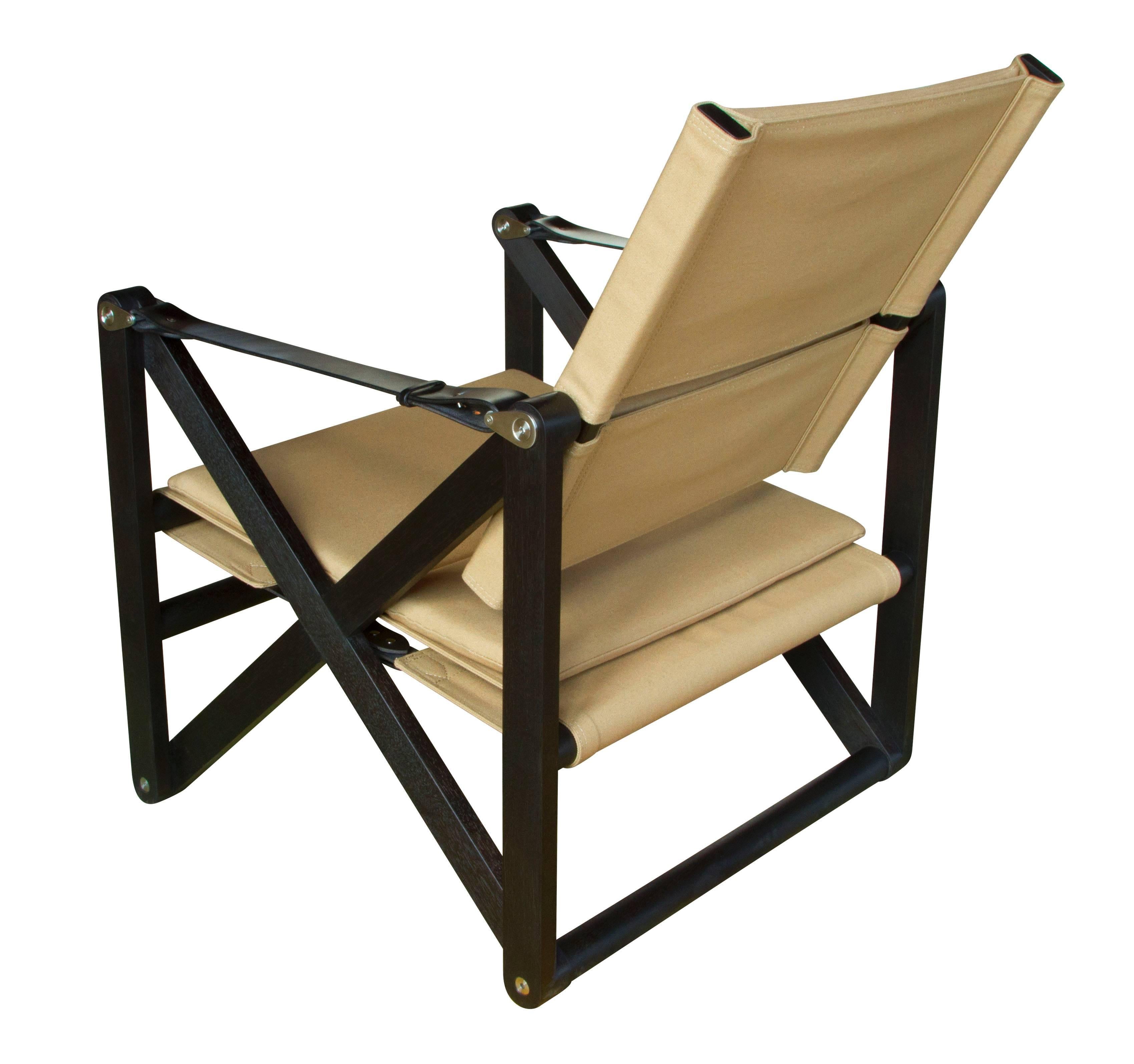 A MacLaren lounge chair in ebonized walnut with khaki canvas and black English bridle leather strapping.

The modern campaign collection by Richard Wrightman combines the vernacular of traditional form with a modern aesthetic, mixing memory with