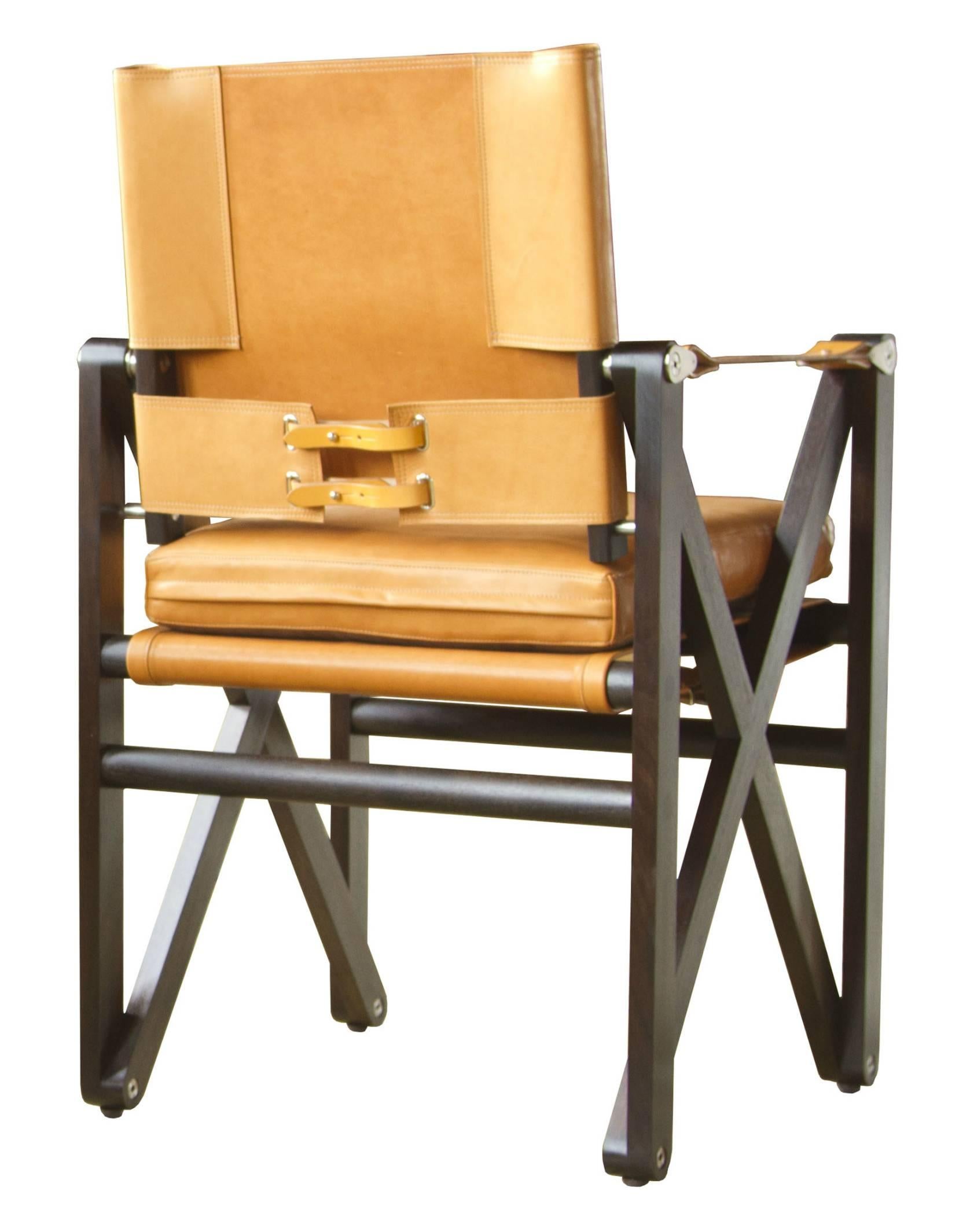 A MacLaren dining chair in Macassar stained walnut with Moore & Giles: Valhalla / Tan leather upholstery and coach English bridle leather straps.

The modern campaign collection by Richard Wrightman combines the vernacular of traditional form with a