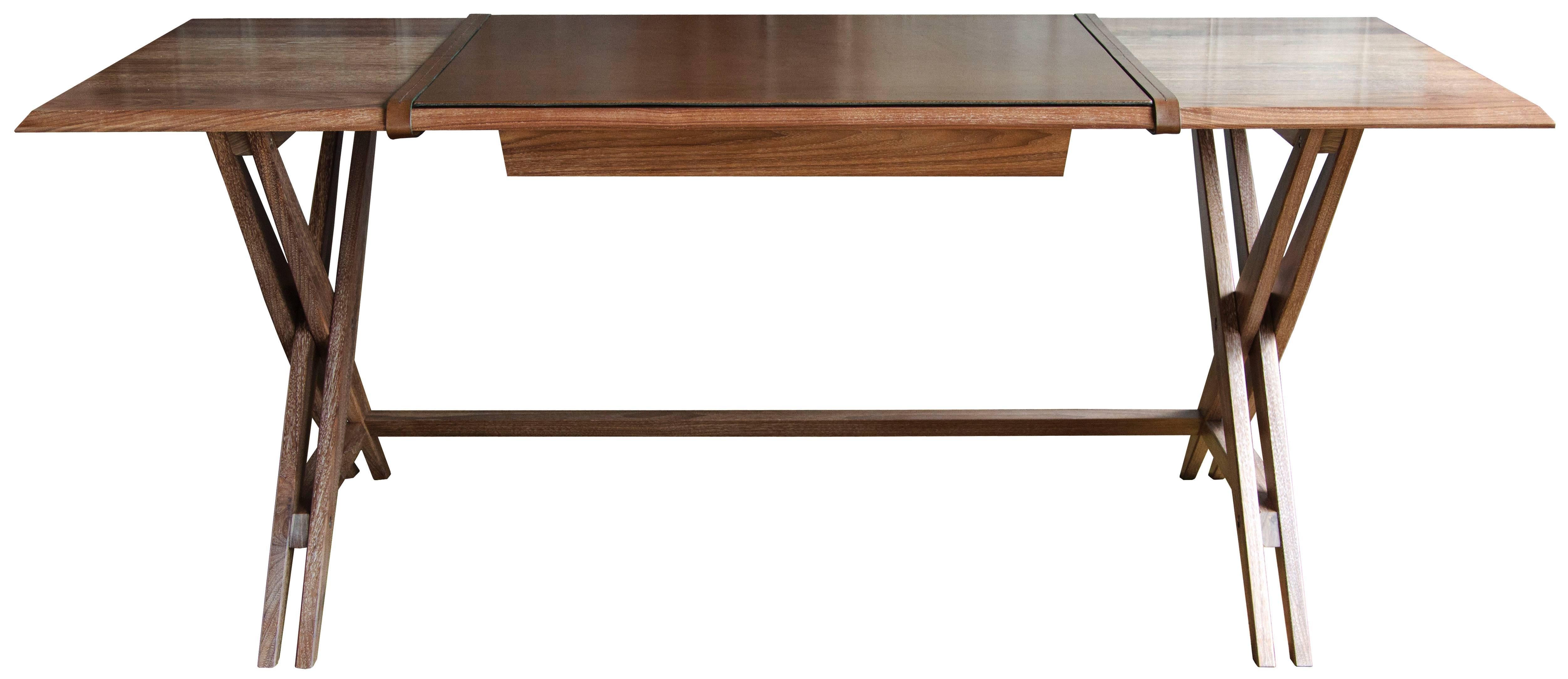 The Octavio desk Type 1 (single drawer) in limed and oiled walnut with Moore & Giles: Diablo / Woodland leather blotter with straps and drawer lining.

The modern campaign collection by Richard Wrightman combines the vernacular of traditional form