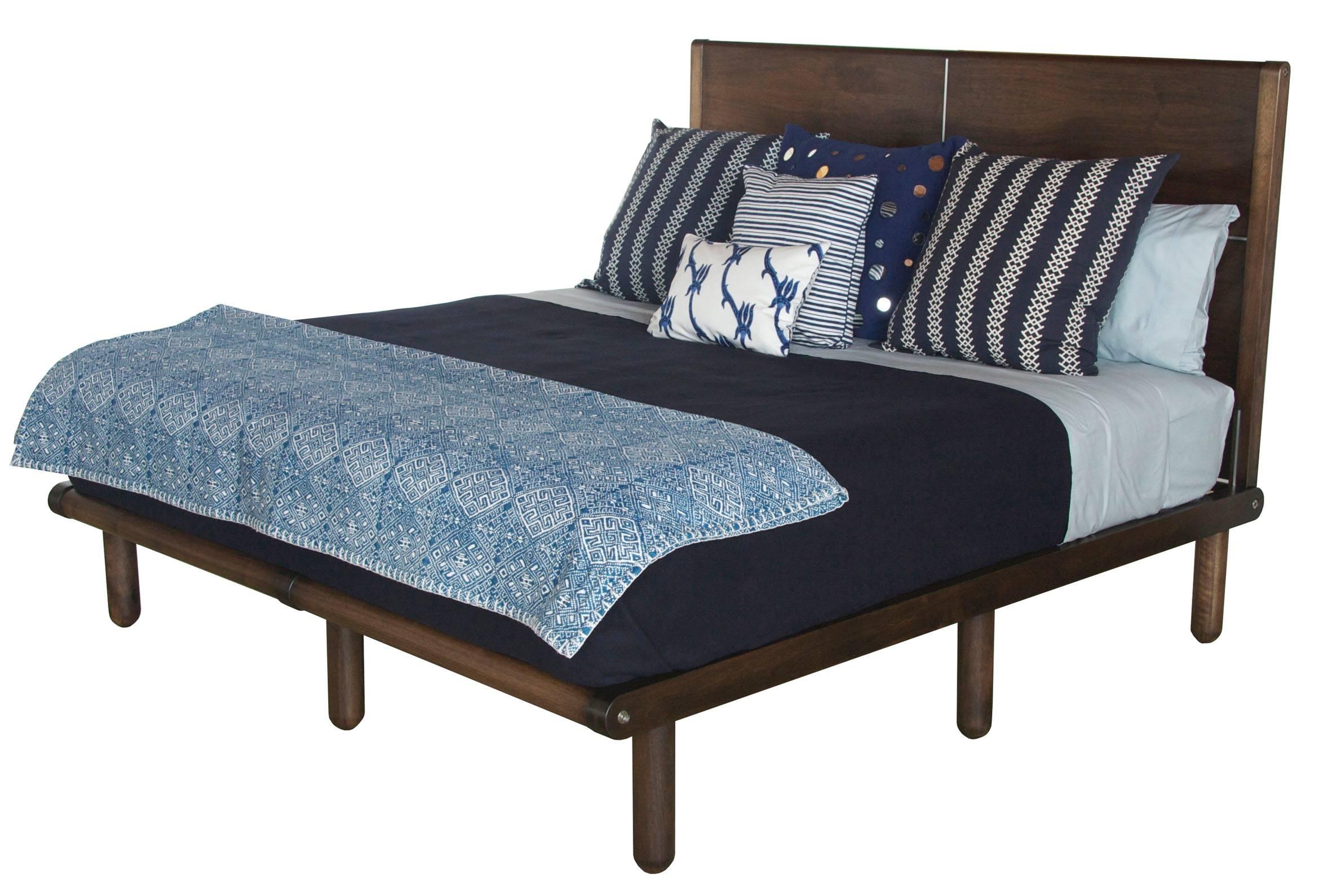 A King sized Isaksen bed in Marrakesh stained walnut with full headboard.

The modern campaign collection by Richard Wrightman combines the vernacular of traditional form with a modern aesthetic, mixing memory with invention, creating pieces that