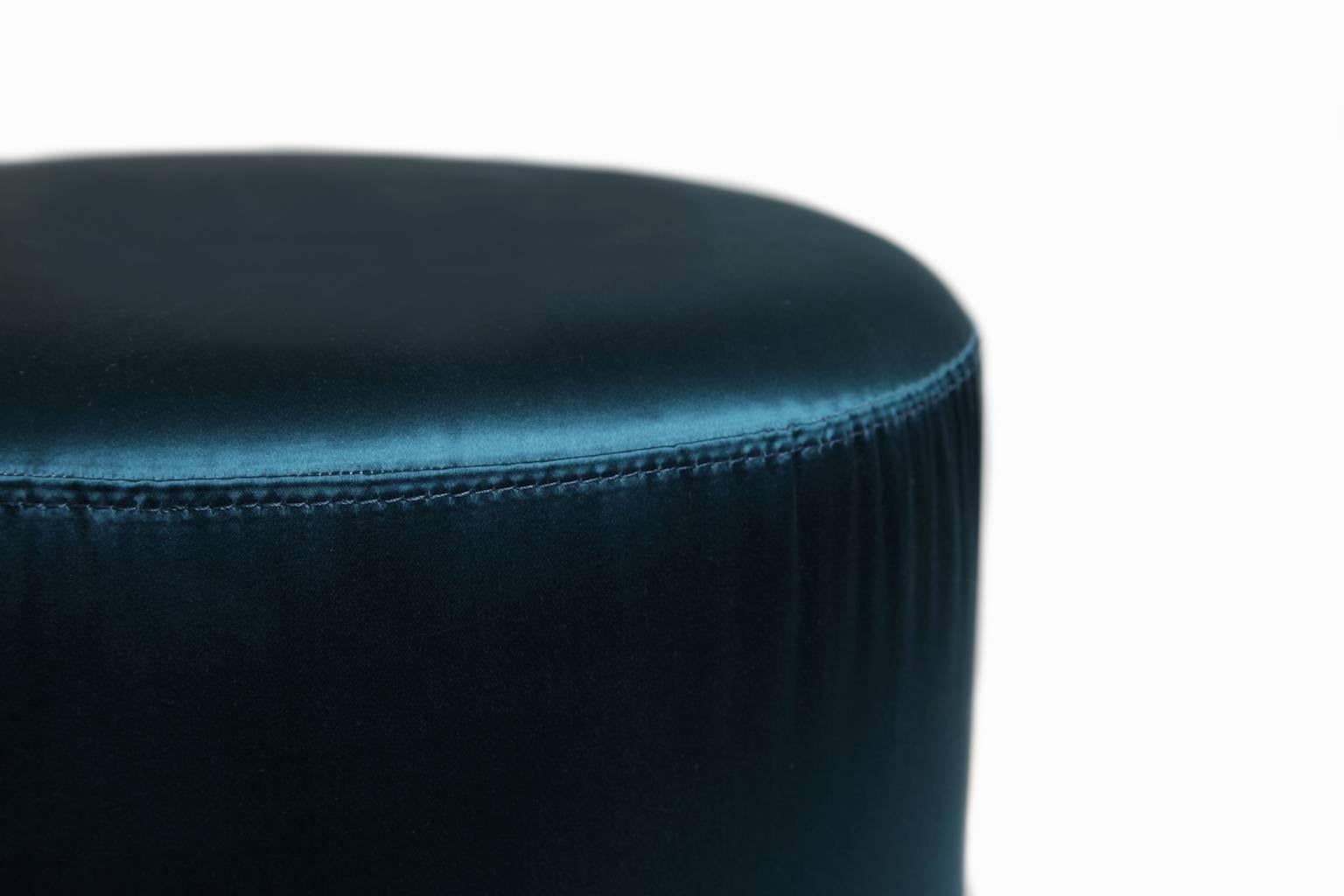 Elegant Pair of cylindrical poufs, in original vibrant petrol blue upholstery, circa 1970s. Brass circolar base.