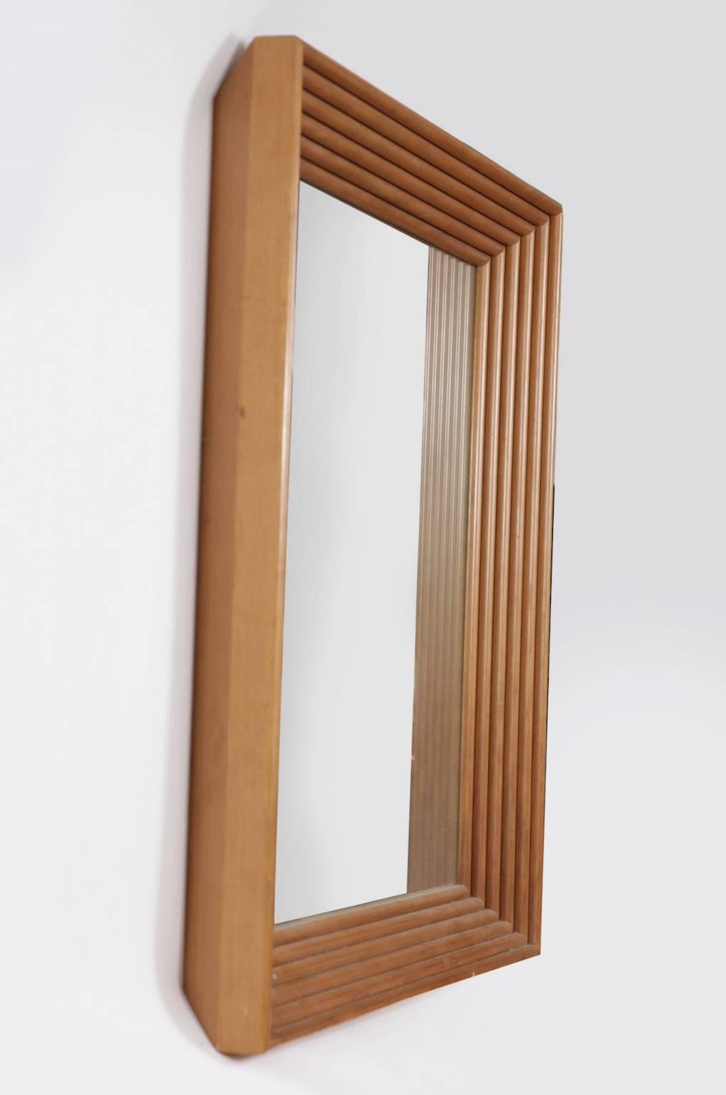 A very attractive mirror from the 1960s with wood fluted frame, is as elegant as it is timeless.