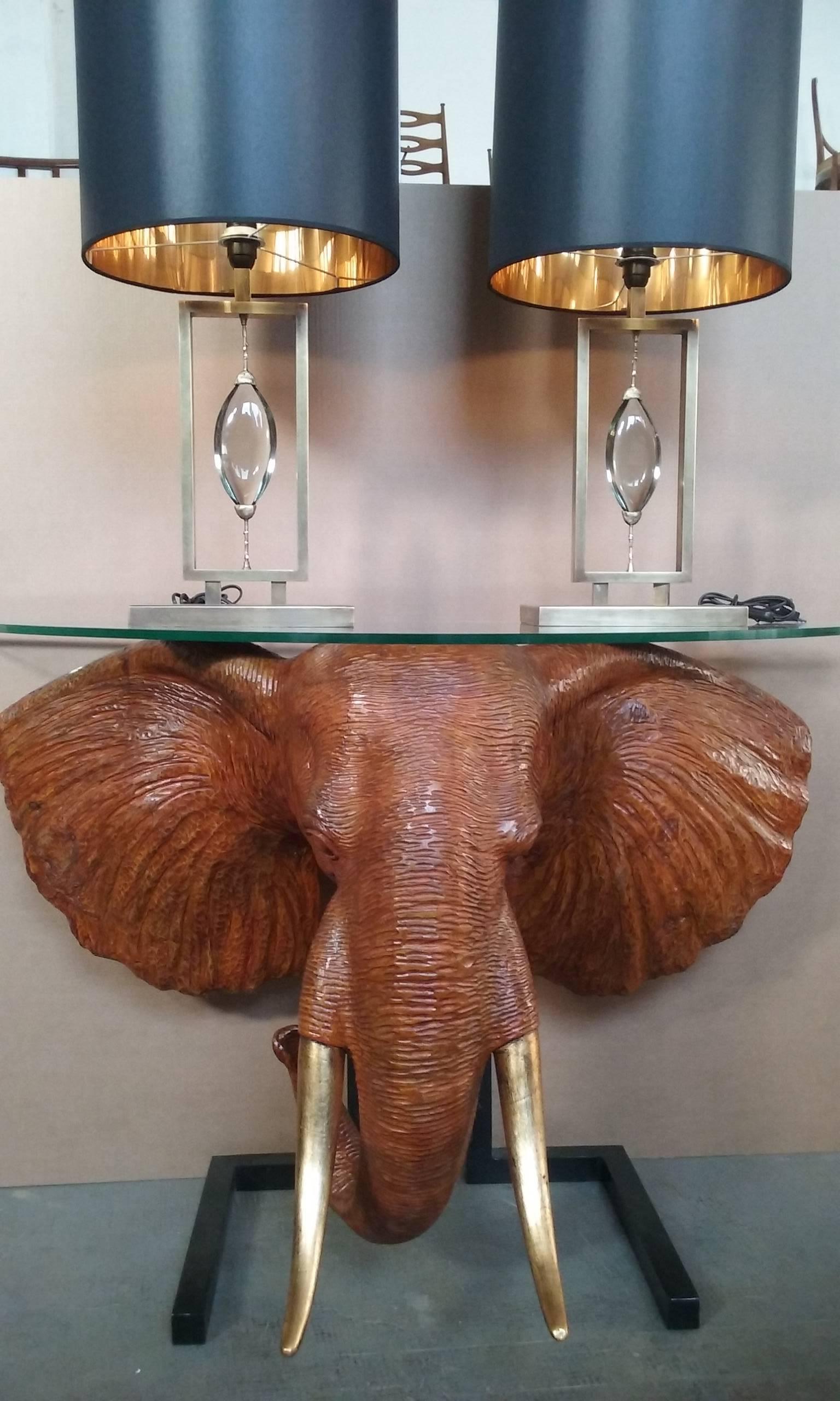 This incredible vintage modern sculpture console features a hand-carved wood base displaying a beautiful elephant, totally carved by hand. Unusual design with exquisite detail from the gold leaf, tusk to the ears. Sleek and refined piece has a hall