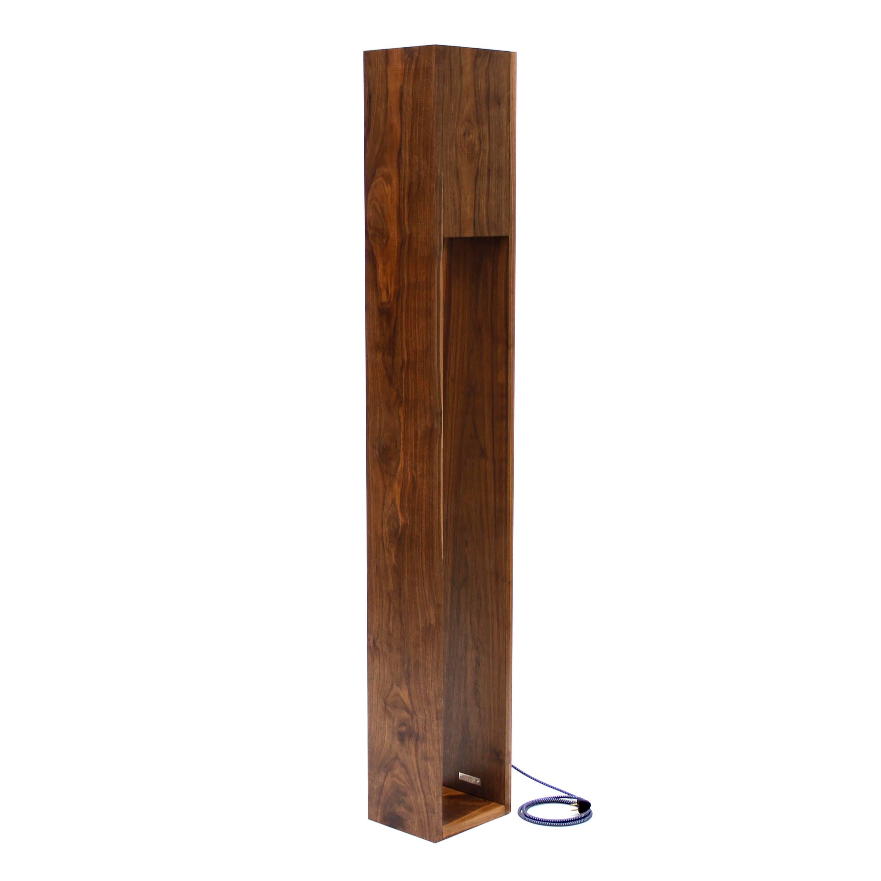 The monolith floor lamp is a simple but striking design. Standing at five and a half feet tall, the lamp provides ample uplight but also allows light emitted downward to illuminate the walnut’s undulating hand oiled grains. The lamp is triggered by