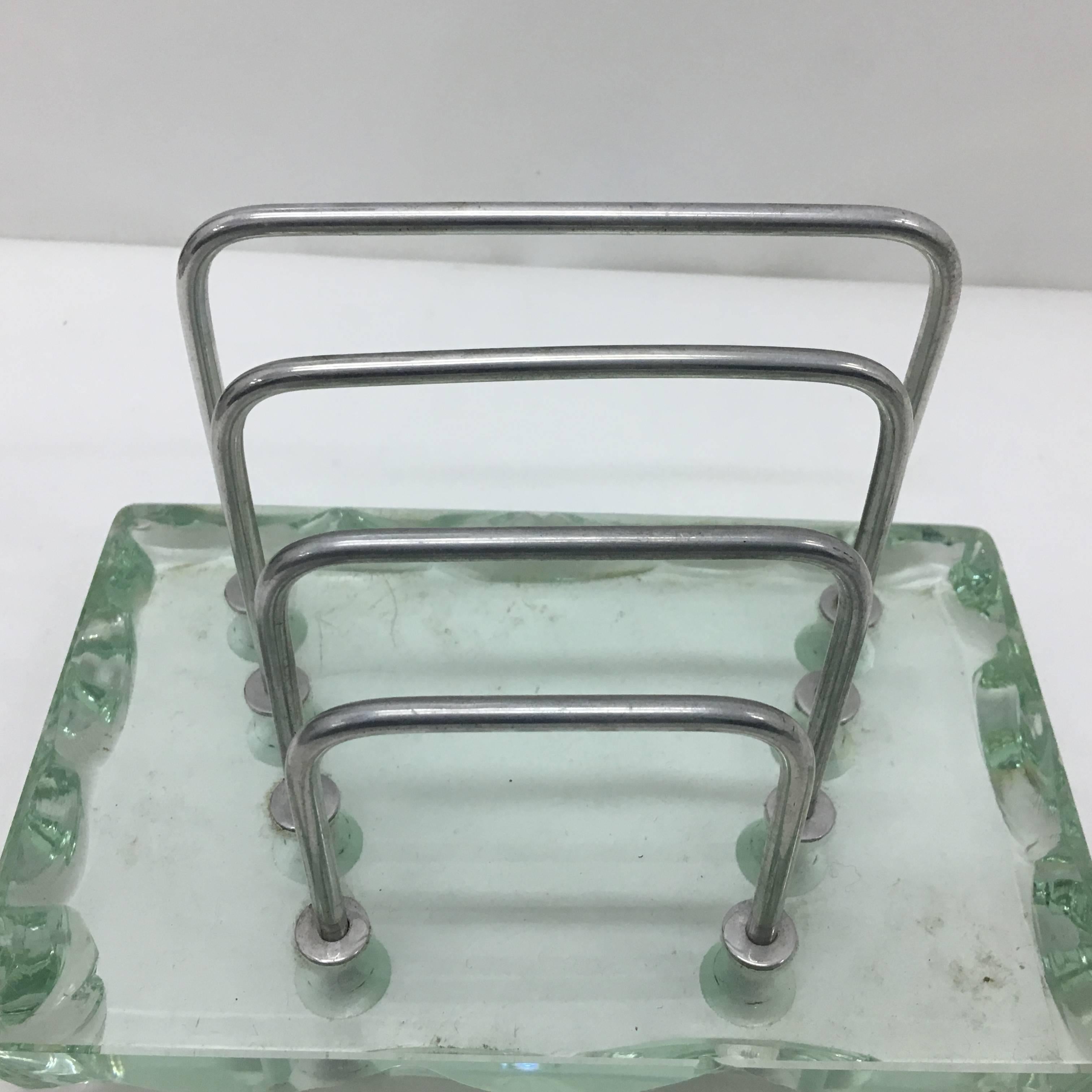 An Italian stylish desk set attributed to Fontana Arte, very heavy verde nilo glass, has been made in 1950s, there is a small chip in one black pen holder. Sizes are of the pen holder tray.
This stunning desk set, attributed to Fontana Arte and