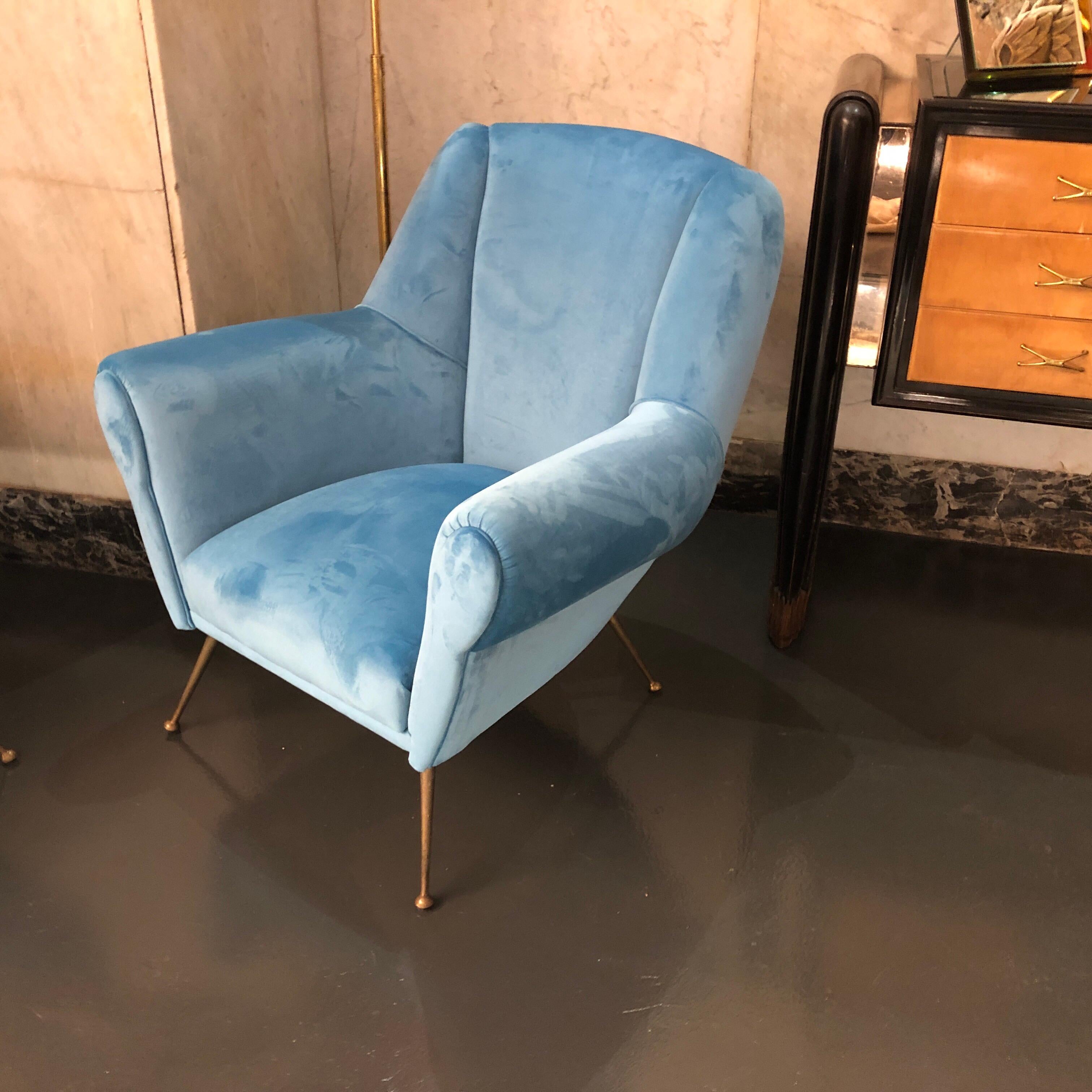 A stylish set of two brass and light blue velvet armchairs. Brass feet are in original patina, the armchairs has been reupholstered.