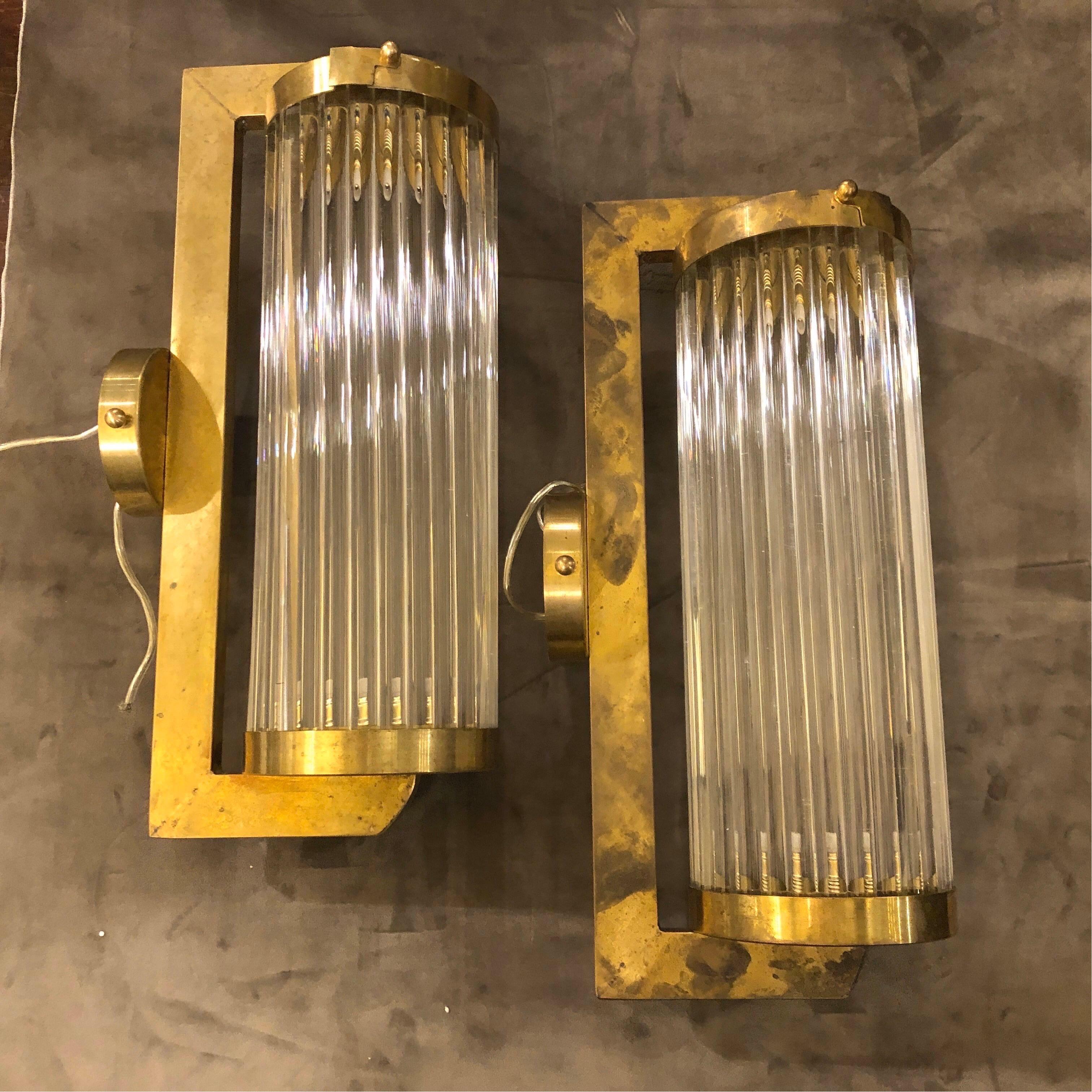 Two Art Deco style Italian Craft wall sconces made in the 1970s, fully restored electrical parts, thy work 110-240 volts and need two regular e14 bulbs. Brass in original patina, the full glass tube can be removed from a small flap to be cleaned and