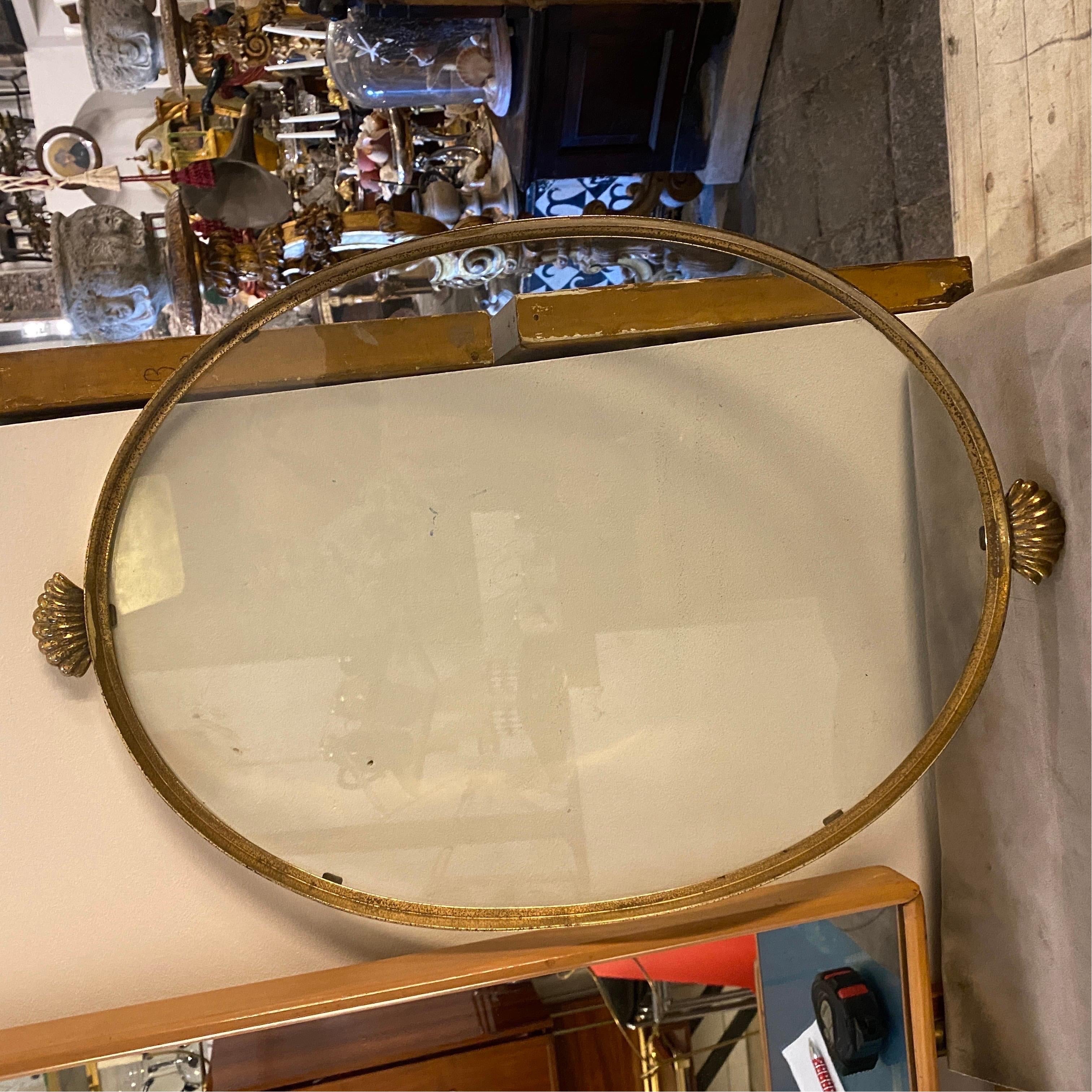 An hand-crafted solid brass and glass serving tray designed and manufactured in Italy in the Fifties. Brass in original patina gives it a superb vintage look .A 1950s mid-century modern oval tray made from brass and glass would be a stunning piece