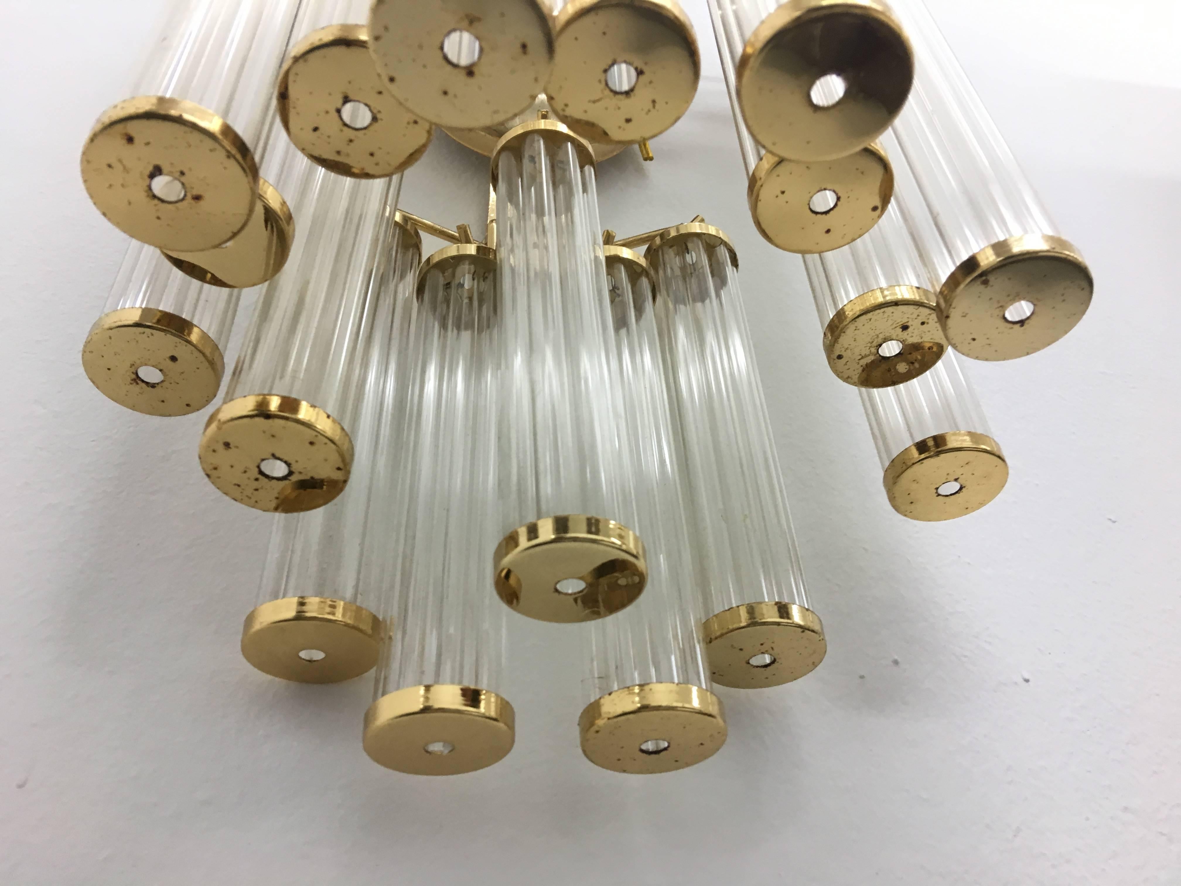 A two lights brass and plastic wall sconce made in Italy attributed to Gaetano Sciolari, circa 1960.
It works with both 110 and 220 Volt.
