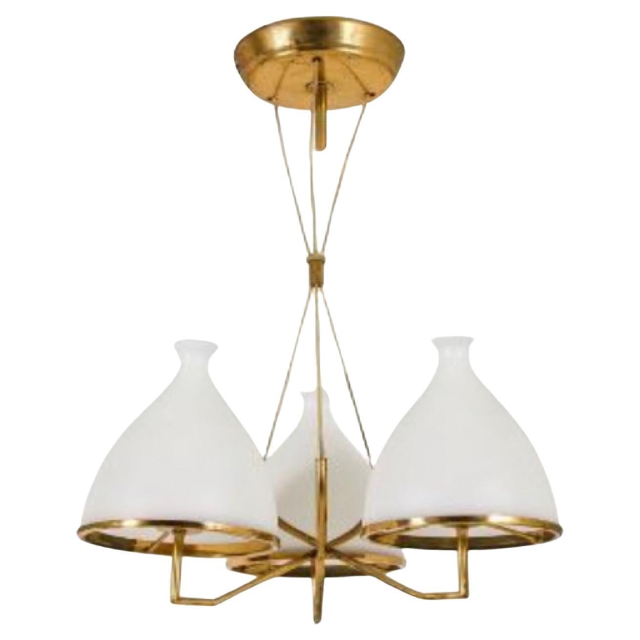 Two amazing chandeliers made in Italy attributed to Stilnovo, circa 1958, the structure in polished brass it's in original patina and the white satin glass diffusers are in excellent conditions. They works 110-240 volts, each chandelier needs three