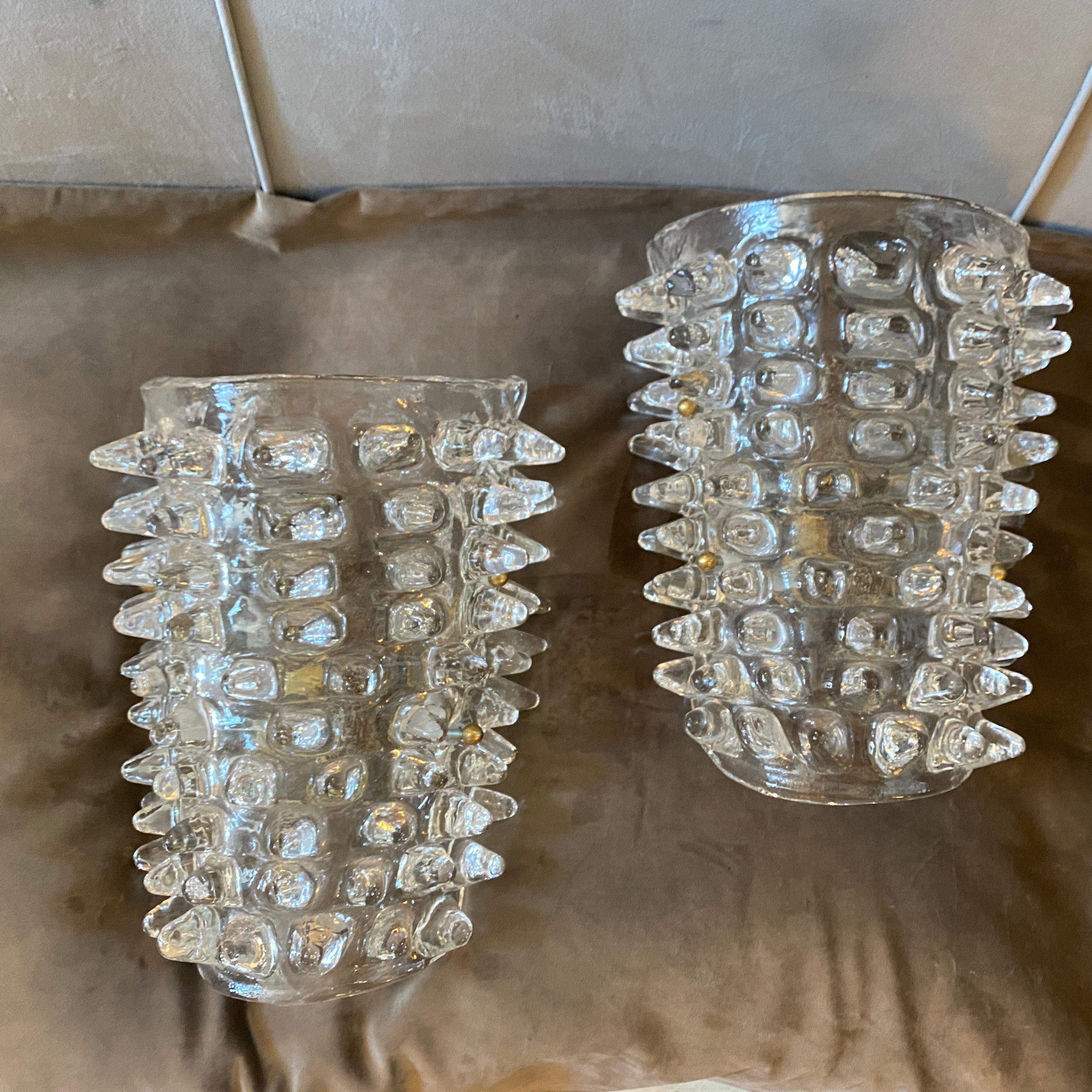 A pair of Mid-Century Modern rostrato transparent murano glass wall sconces hand-crafted in Italy in the style of famous manufacturer Barovier that invented this particular glass processing characterized by large light-reflecting points, obtained