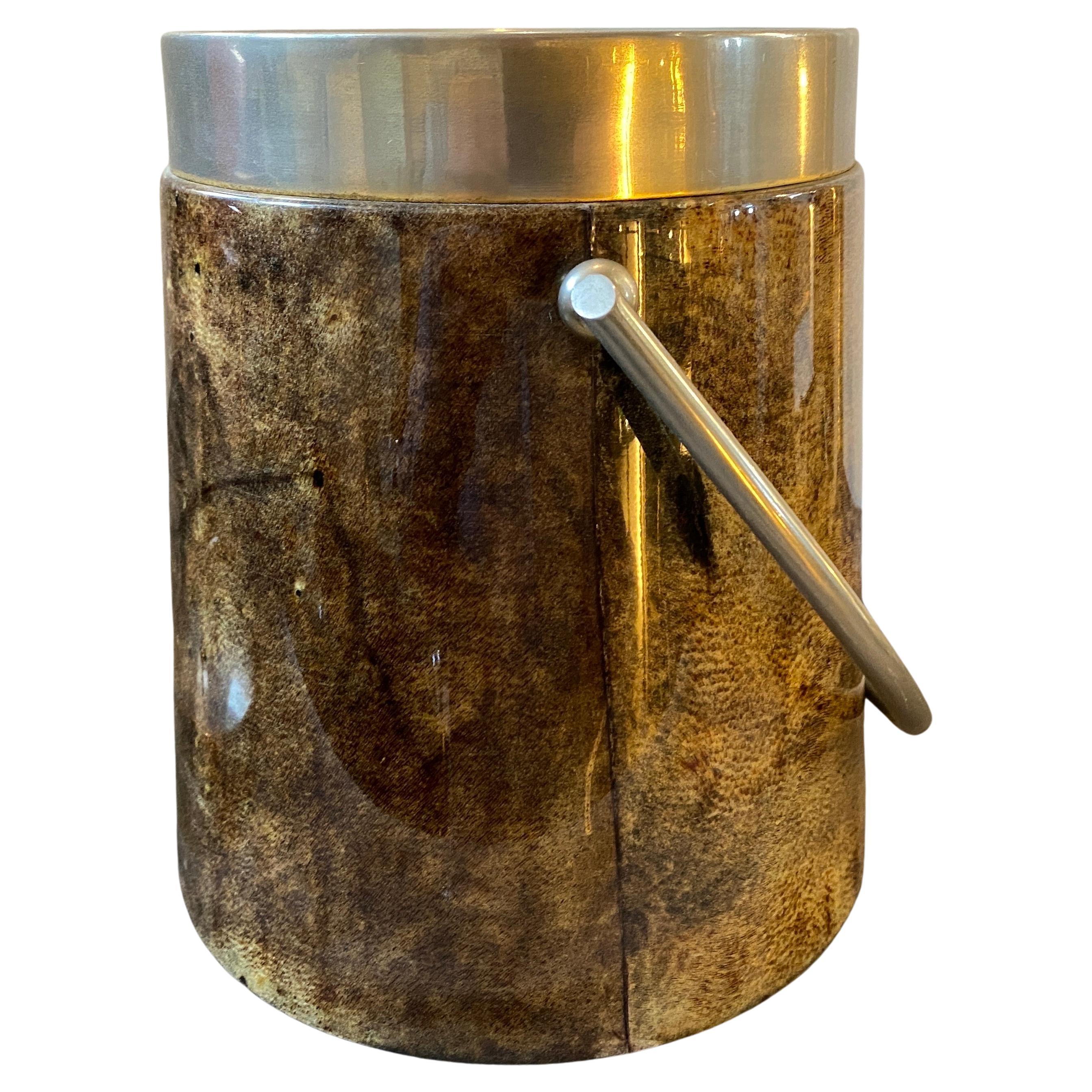 An amazing brown goatskin and metal ice bucket designed by Aldo Tura and manufactured in Milano by Atelier Tura in the Sixties. the ice bucket can also used as a wine cooler, it's labeled on the bottom. Aldo Tura is an Italian designer, who