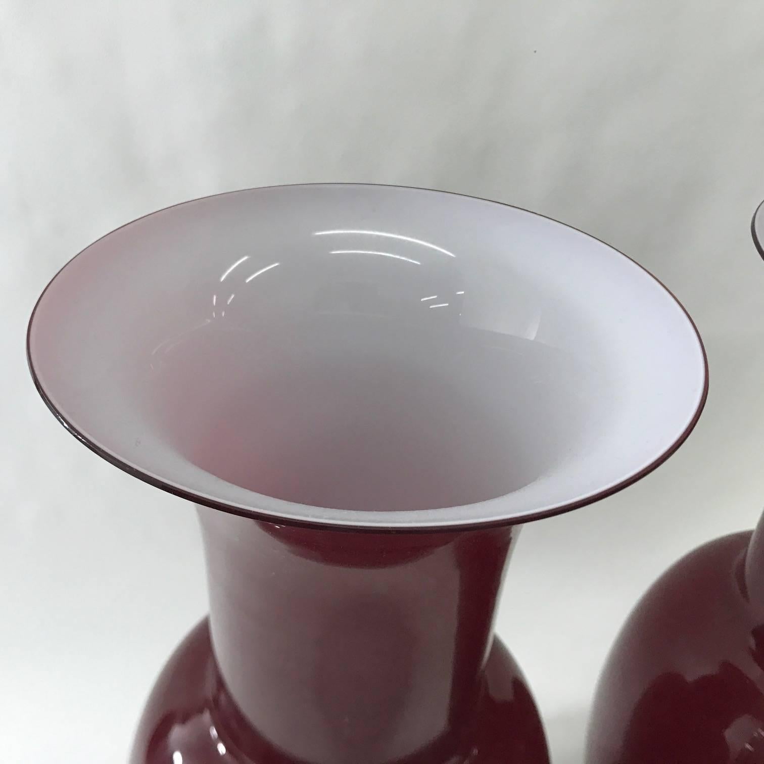 Pair of Murano glass vases signed by Aureliano Toso, made in 2001, red color and white inside, good conditions overall.