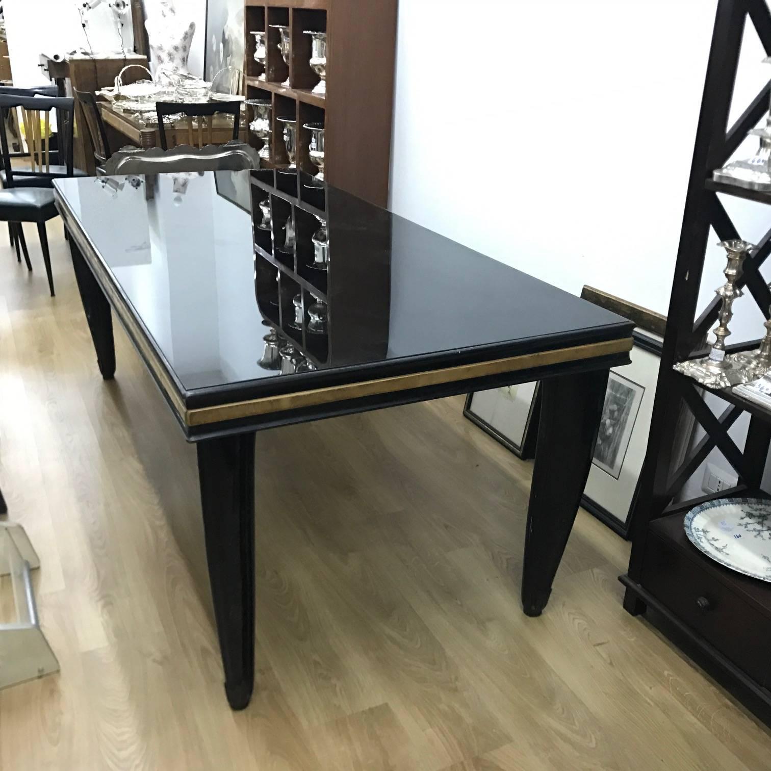 Superb quality Italian dining table, black glass on the top, three colors of wood, big size and good conditions overall.
