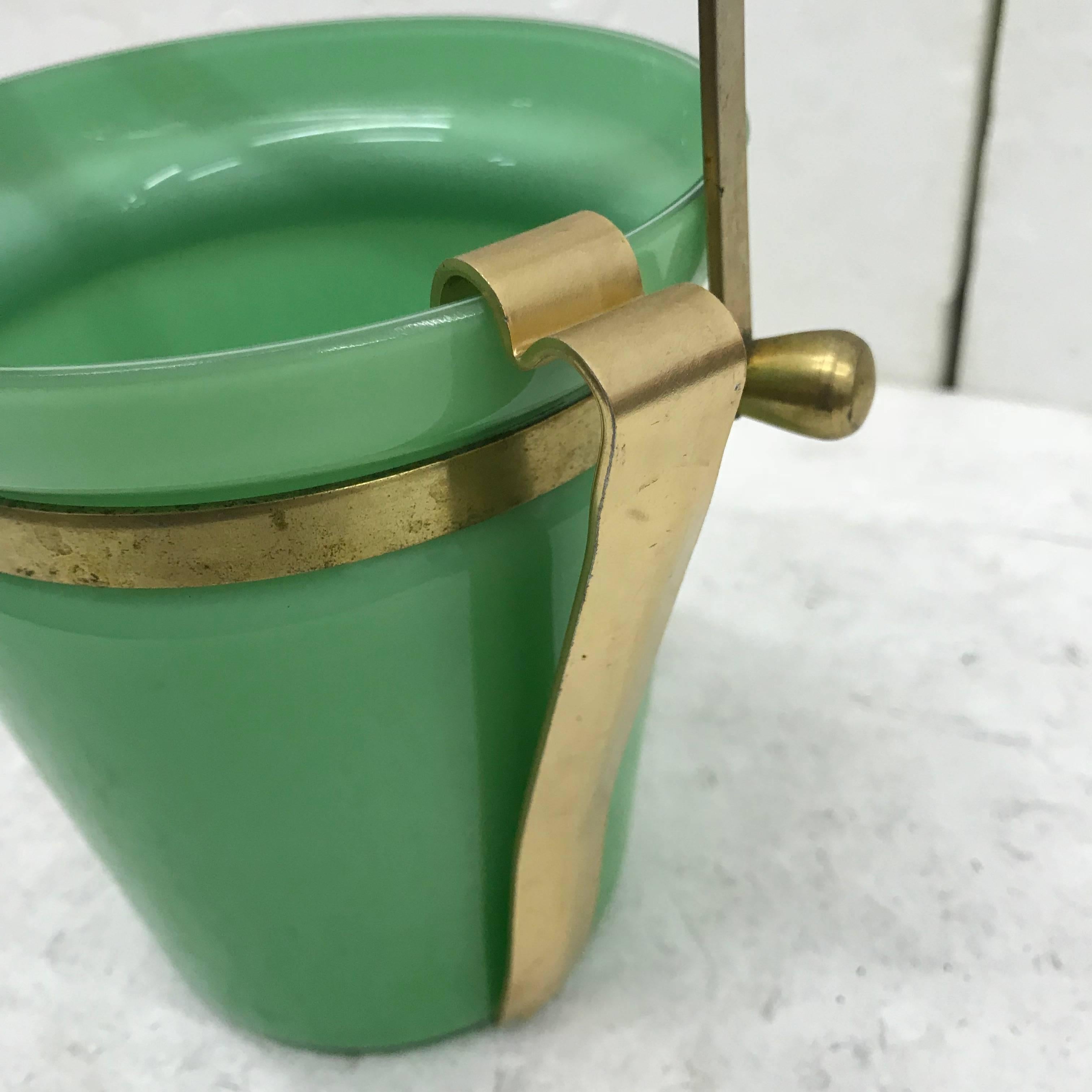 This is a brass and green opaline ice bucket made in Italy in circa 1950.