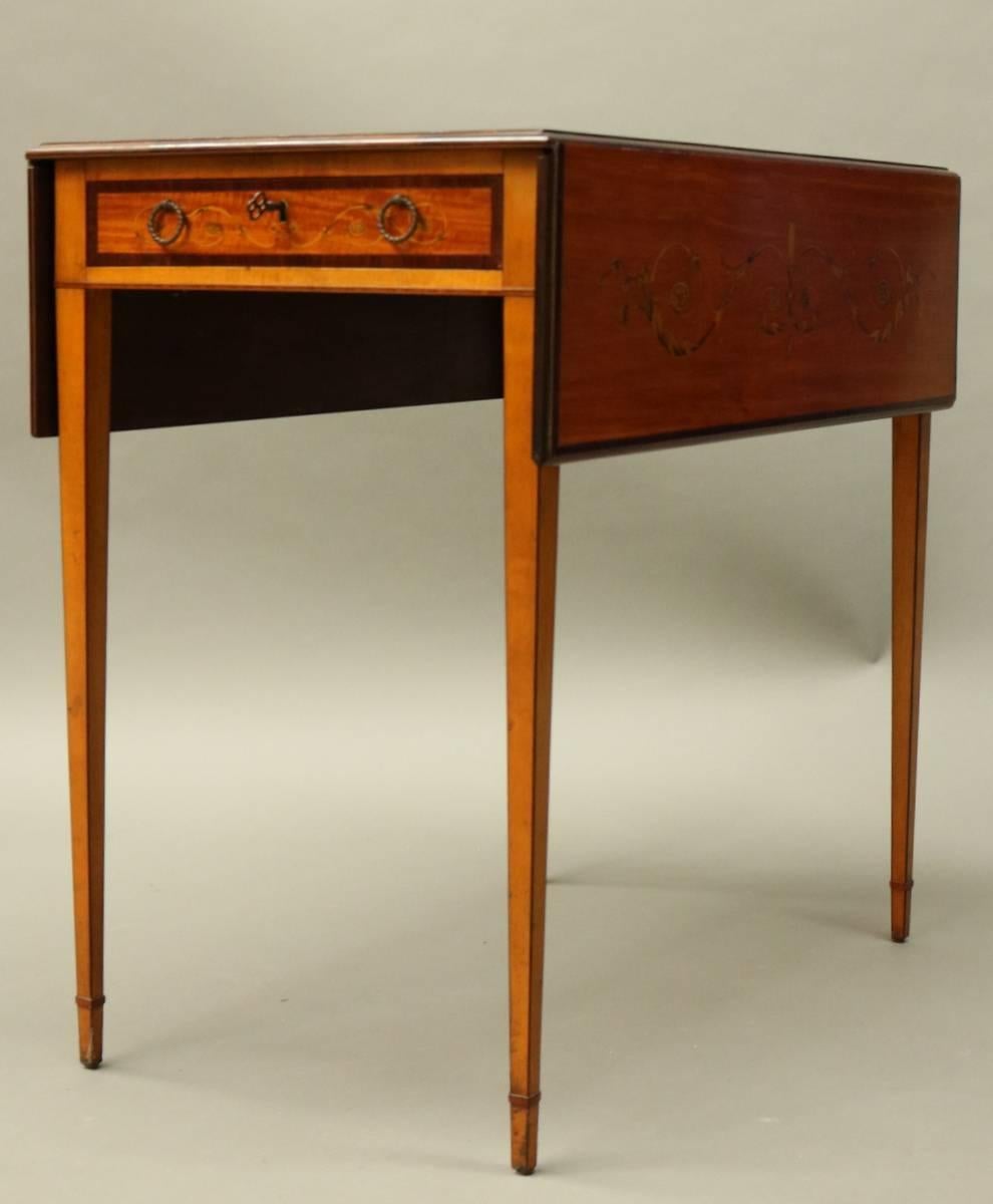 English satinwood, mahogany and rosewood marquetry pembroke table features exquisite neoclasiscally inspired inlay throughout, finely tapered legs, single drawer, and superior proportions, circa 1900.