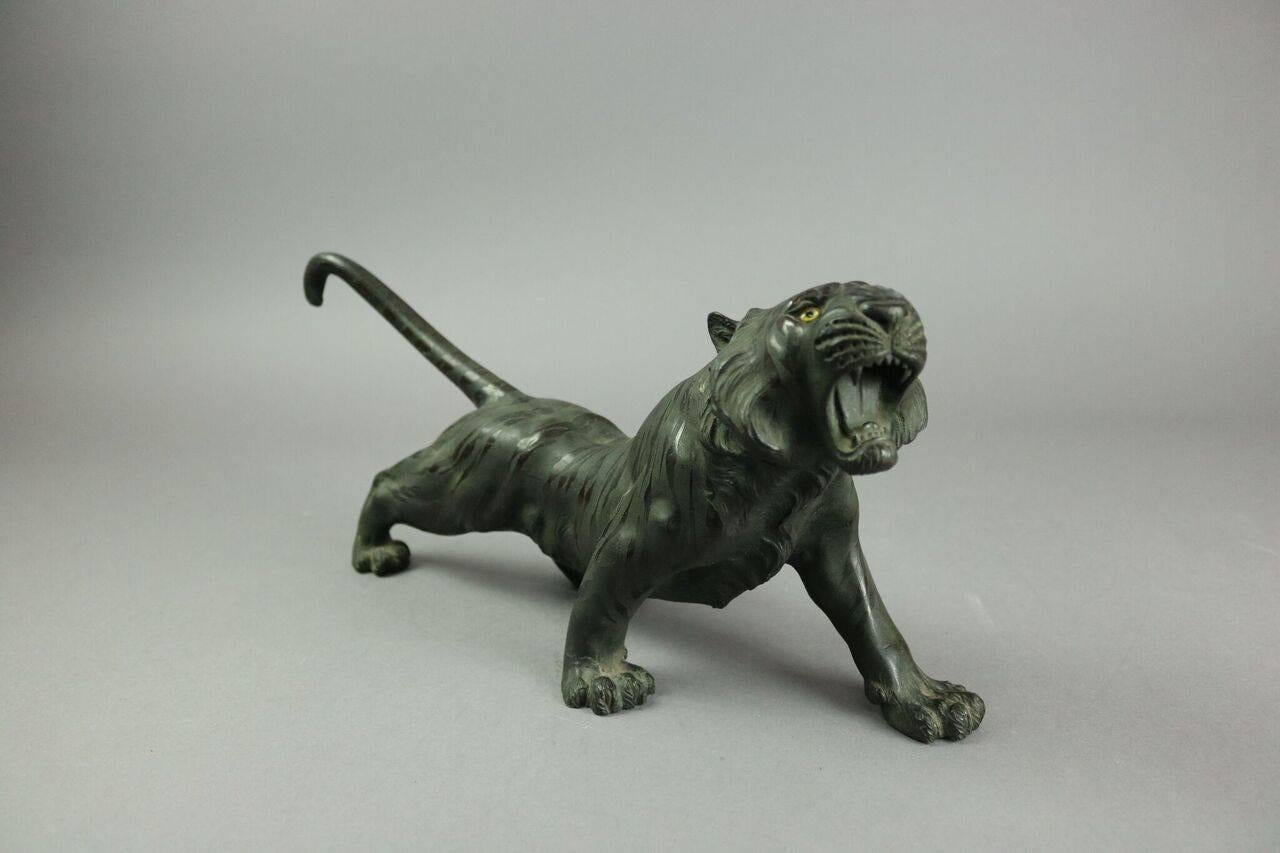 Late 19th century, Japanese bronze sculpture of a tiger with glass eyes.