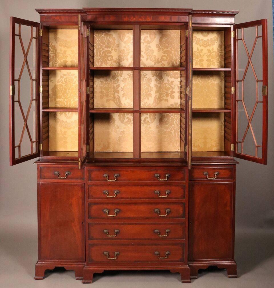 18th Century English George III mahogany banded and inlaid breakfront cabinet four glass upper doors opening to china compartment, two bind door compartments, five center drawers, two smaller upper drawers and added lighting (not working).