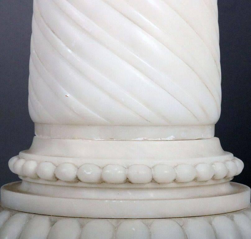 Near pair of antique French, hand-carved alabaster sculpture pedestals feature twisted rope, reeded and beaded decoration, circa 1900. Referred to as "near pair" due to slight difference in height (43" H & 42" H), circa 1900.