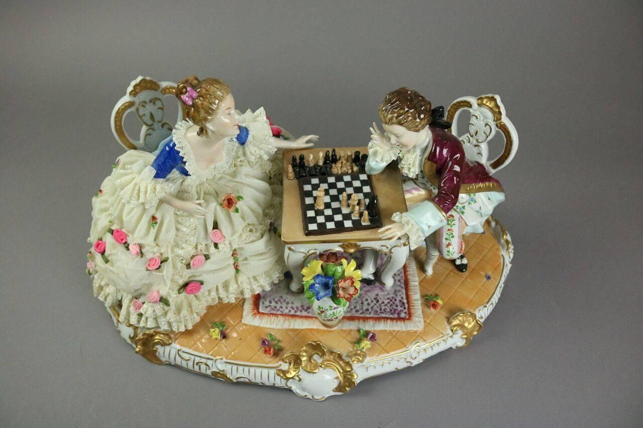 Late 19th century German polychrome Dresden Lace style Unterweissbach porcelain figural group of courting couple playing chess, stamped with blue crown Unterweissbach mark and incised D. Enders on base.