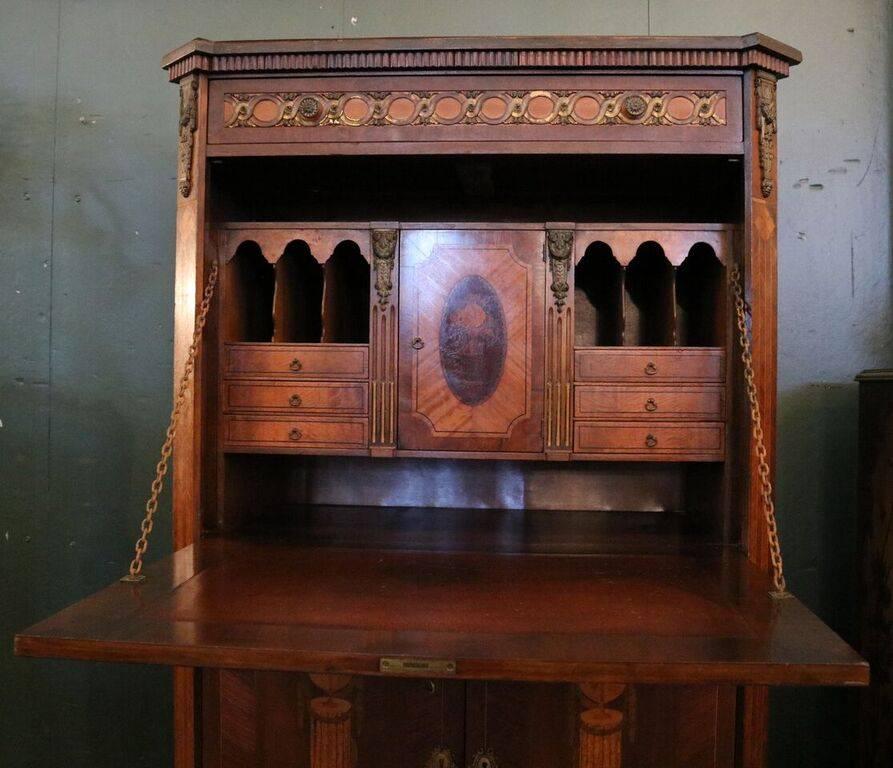Intricately inlaid Johnson Bros. French Biedermeier style Secrétaire à Abattant (fall front desk) features mahogany construction with fine satinwood marquetry throughout and bronze accoutrements, especially detailed is the pictorial marquetry