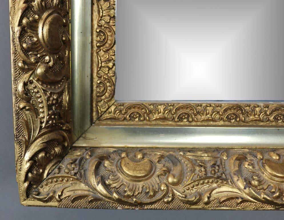 Antique French style first finish gold giltwood frame features C-scrolls and foliate motif surrounding later rectangular plate, circa 1880.


Measures: 32.5