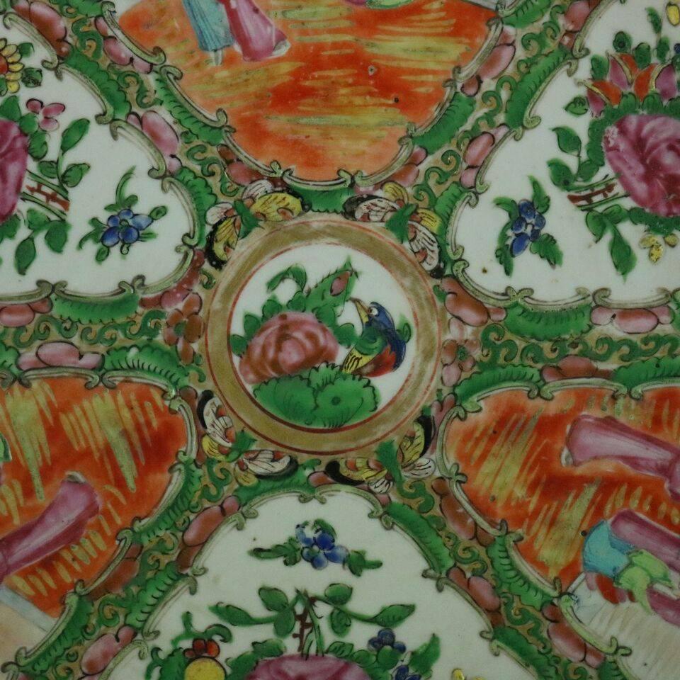 Antique Chinese hand-painted porcelain Rose Medallion charger depicts traditional alternating panels of floral and village scenes with floral central medallion, late 19th century.

Measures: 14.5" diameter.