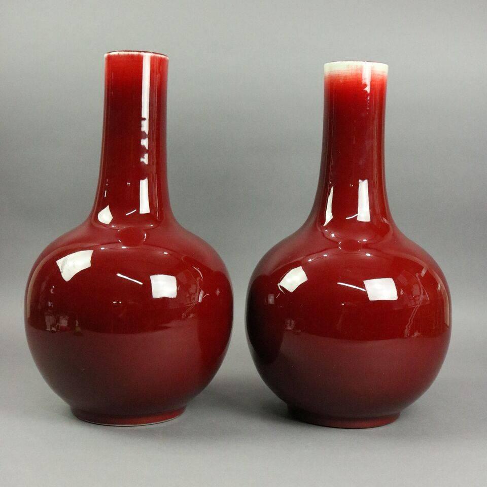 Rare pair of Chinese tianqiuping (globular) pottery vases feature mirror-like oxblood flambe copper red glazing with stamp on base, late 19th century.

Measures: 17.75" H x 9" diam

Tianqiuping; globular vases
First developed during the