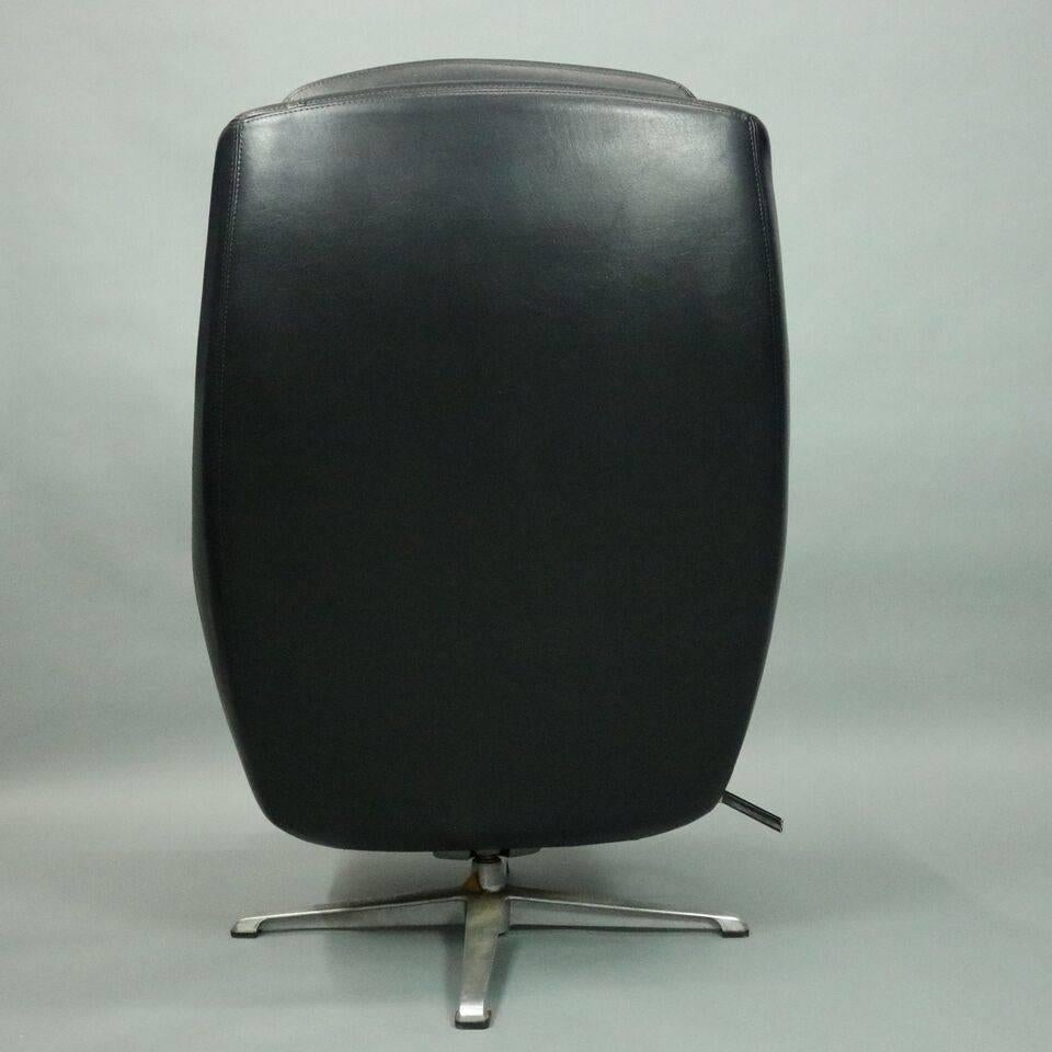 American Mid-Century Modern Eames Style Black Swivel Shell Chair and Ottoman, circa 1960