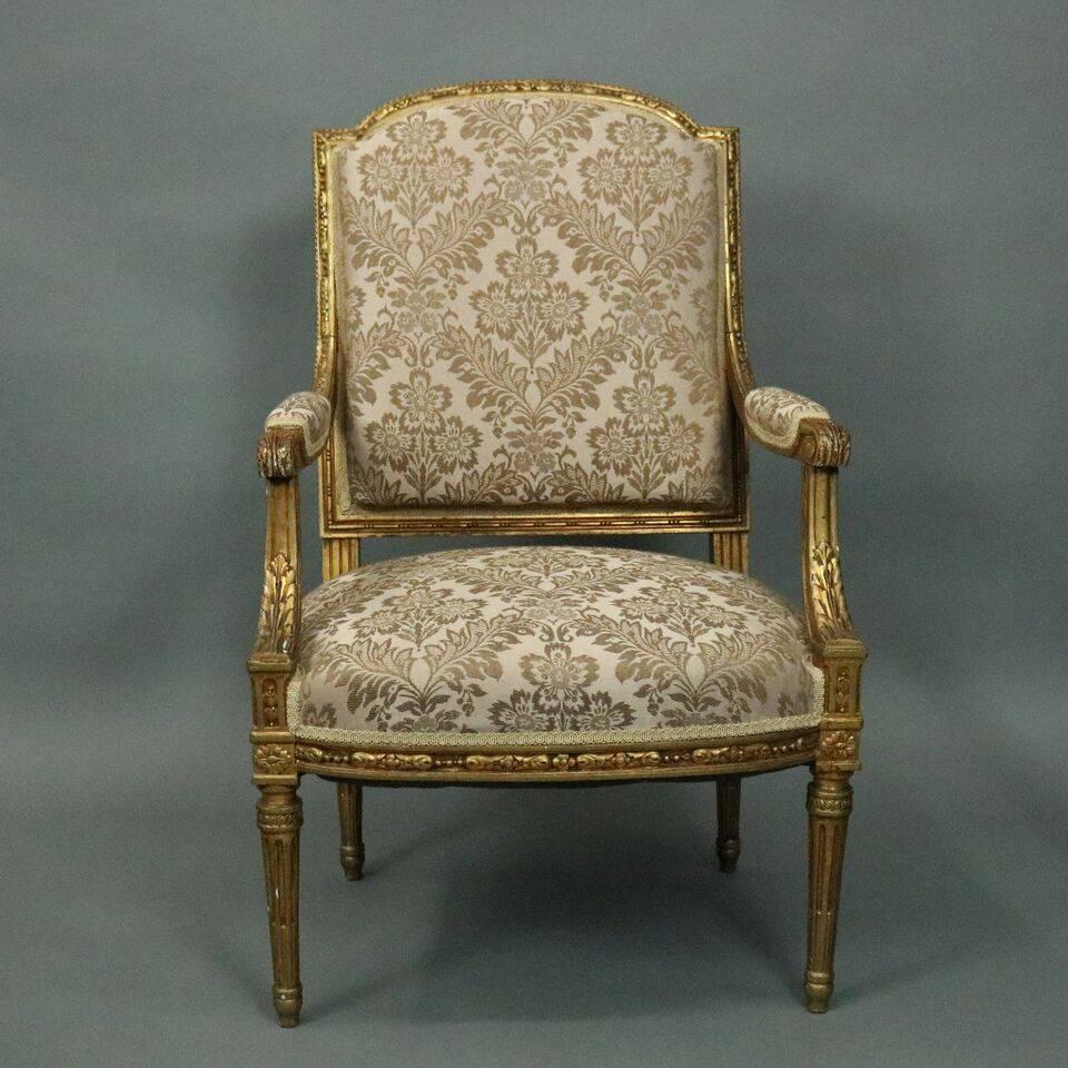 Pair of antique French Louis XVI armchairs a la reine, perfecty proportioned and exceptionally elegant, feature traditional gold gilt framing with carved laurel molding, en chapeau back, set-back arms with arm pads terminating in carved acanthus