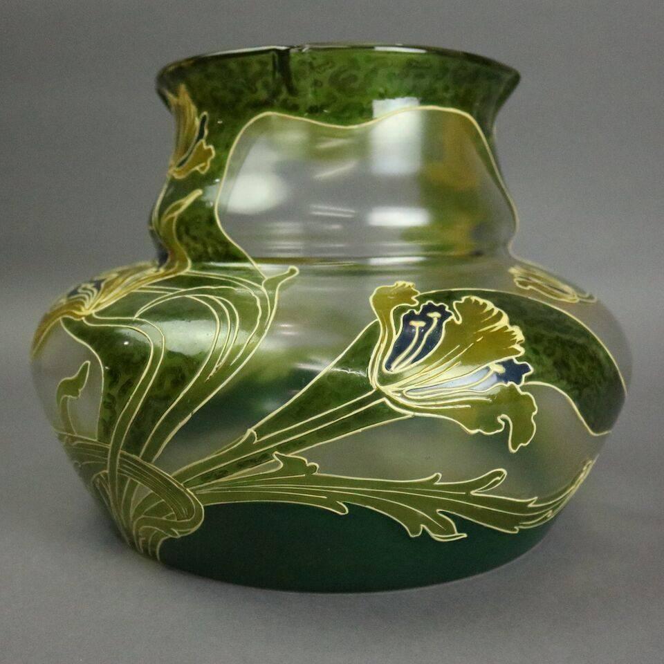 Antique French Mont Joye Art Nouveau mouth blown art glass bulbous vase depicts lily motif against a fluid organic green backdrop, unsigned, circa 1900.

Measures: 7.75" height x 10" diameter.