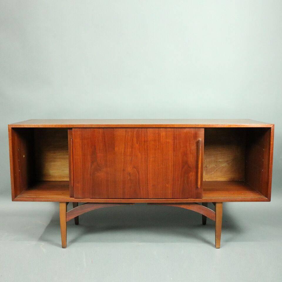 Mid-Century Danish Modern teak credenza or record cabinet features solid wood construction with double sliding doors opening to reveal shelved compartments (shelves are included but not in photographs), circa 1960.

Measures: 29.5" H x