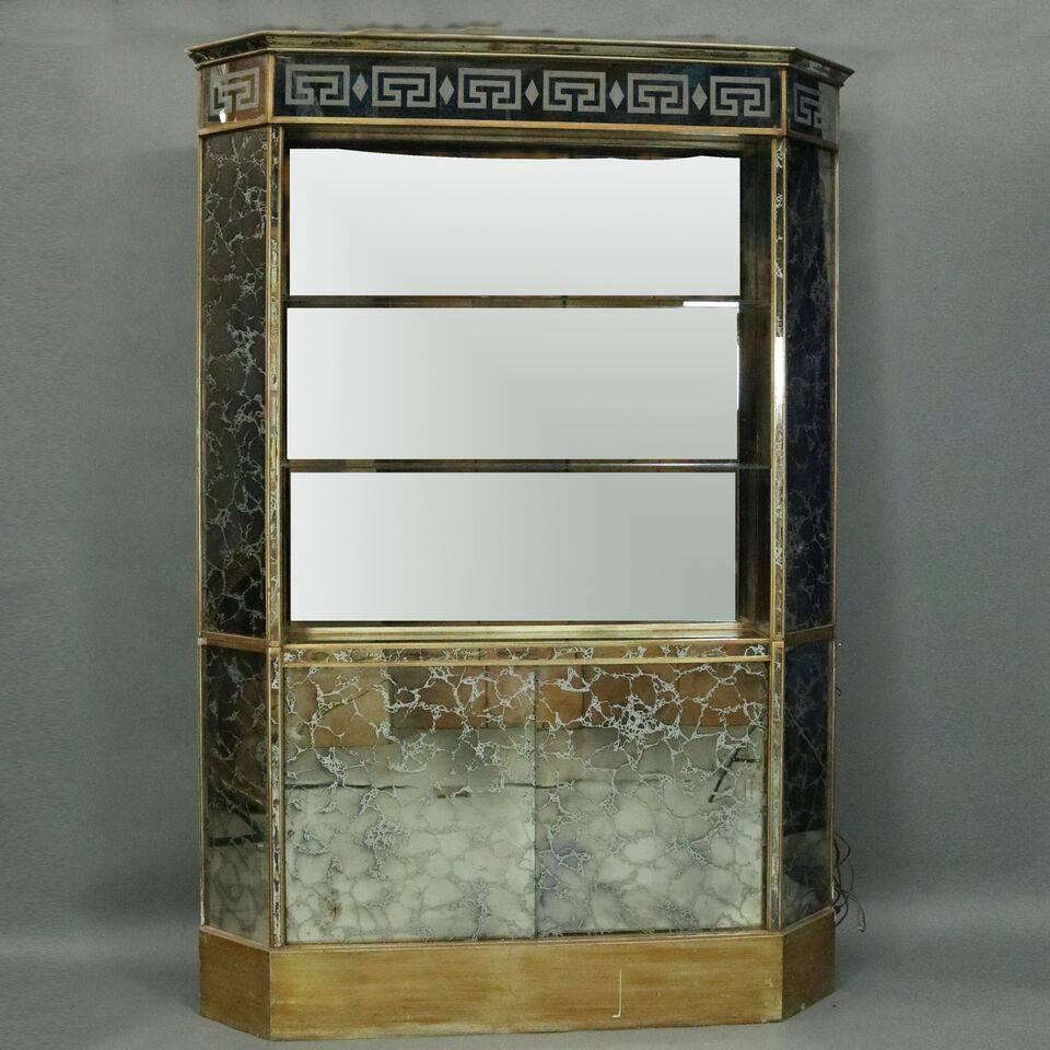 Mid-Century Modern fully mirrored set features bar with interior shelving and mirrored-back cabinet with shelving and sliding doors which open to reveal a mirrored interior storage compartment. Both pieces are covered in veined mirror and