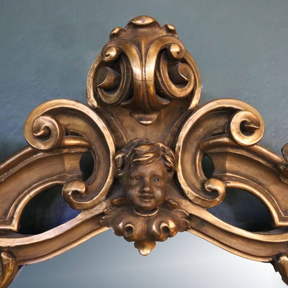 Oversized antique French overmantel pediment mirror features traditional Louis XIV style ornate giltwood surround of floral, scroll and foliate decoration with central mask on pediment crest, circa 1890

***DELIVERY NOTICE – Due to COVID-19 we are