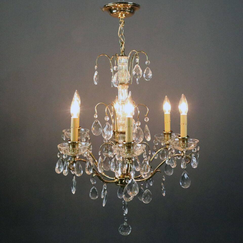 Vintage French chandelier features bronze frame with six arms terminating in drip candle lights and laden with Swedish drop cut crystals, circa 1950

Measures: 35