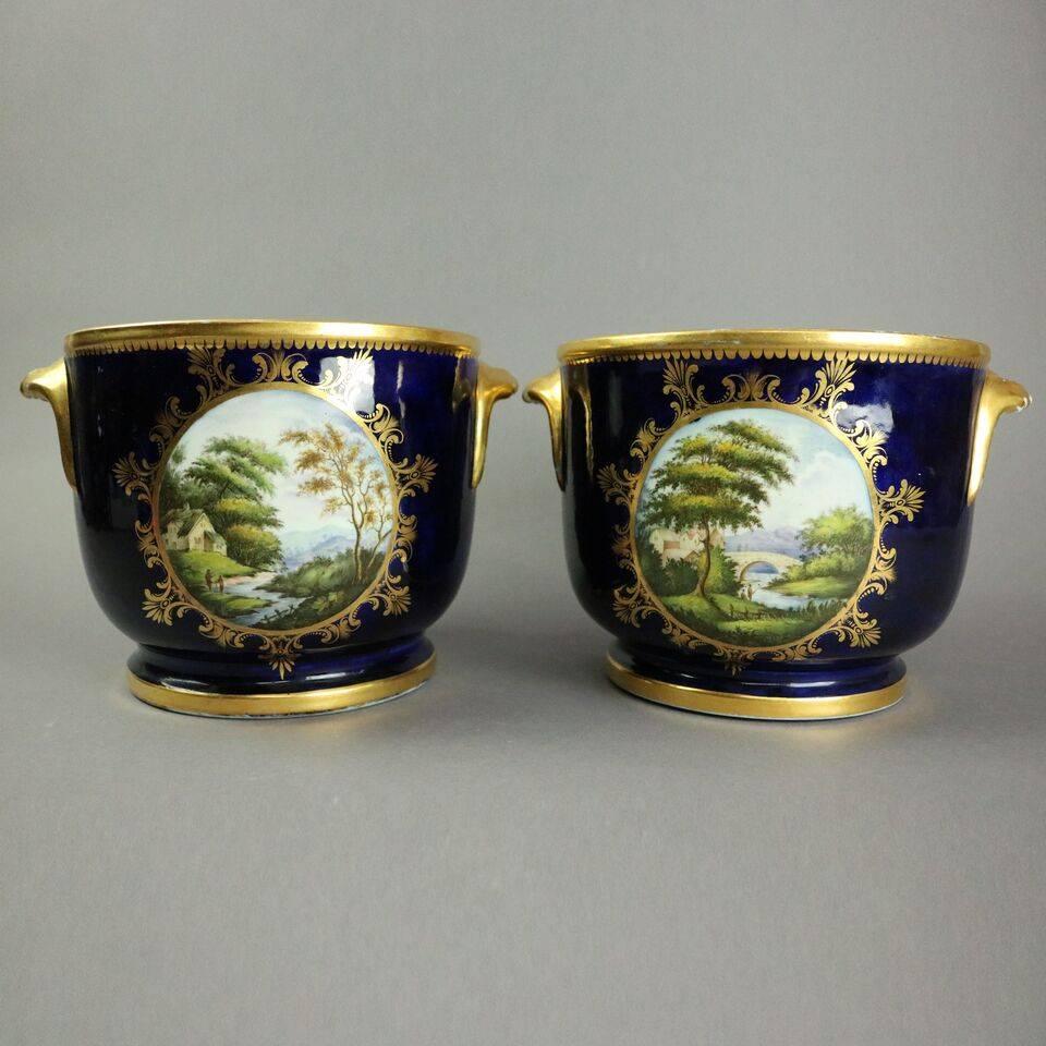 Antique pair of fine English Chelsea School cache pots feature hand-painted panels of bird and landscape scenes on blue ground accented in gold, circa 1830

Measure- 7.5" H x 7" diameter.