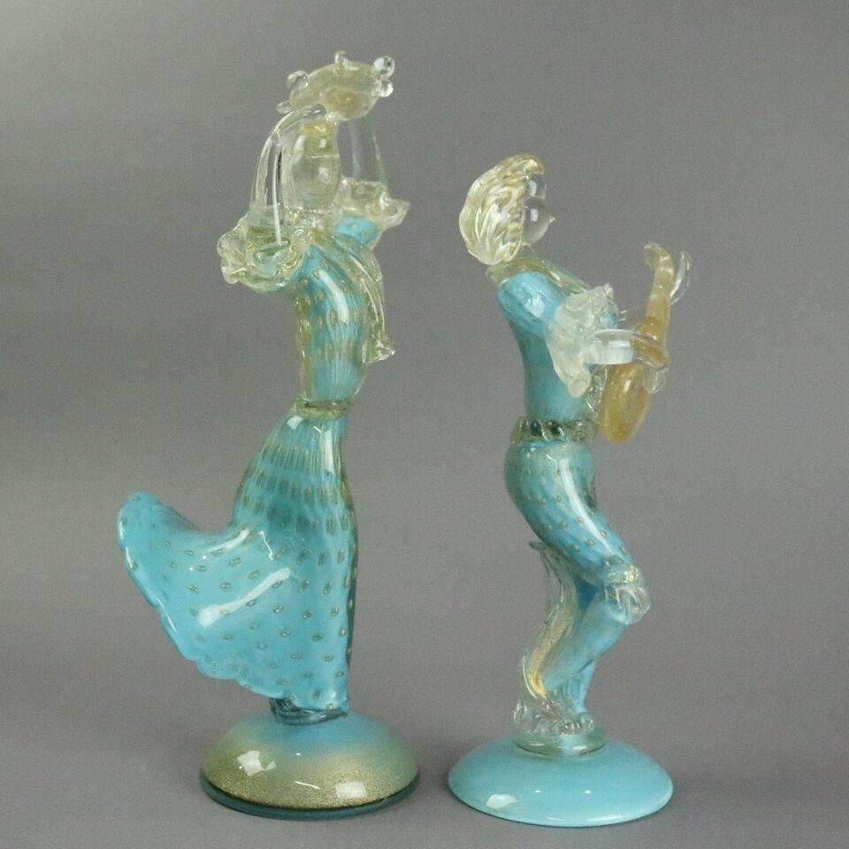 Mid-Century Modern pair of Italian Murano Barbini School glass figures depicting musician playing guitar and dancing lady the Salsa, both in aqua blue highlighted with gold, circa 1960

Measure: 14" H x 7" D.