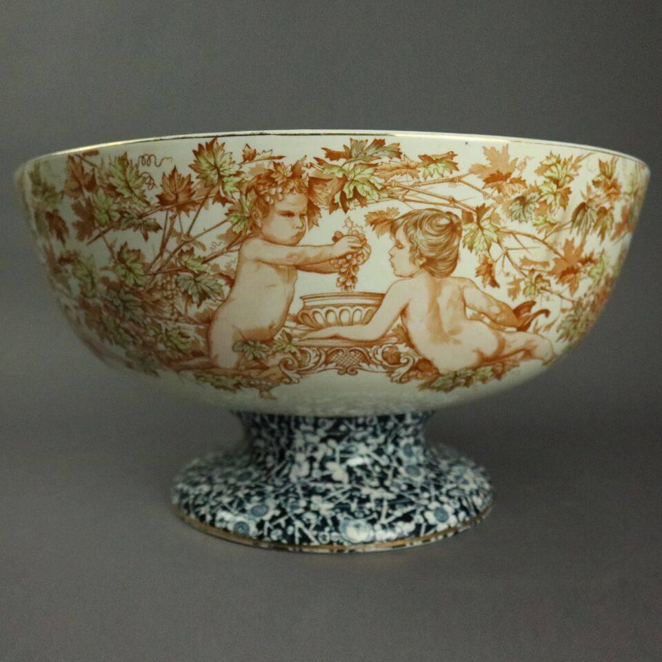 Antique English Maddocks Lamberton works transferware porcelain footed punch bowl features foliate and cherubim exterior, scrolled foliate banded interior with floral spray central medallion, Crown "M" Maddocks Lamberton Works stamp on
