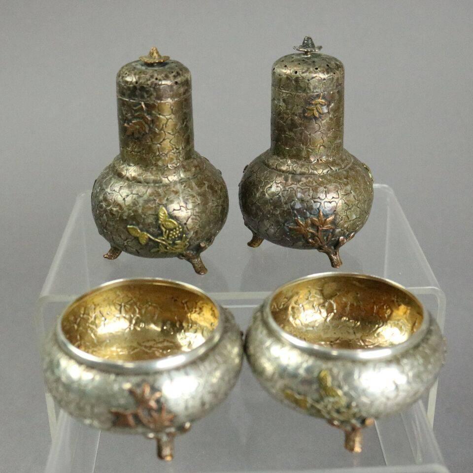 Antique aesthetic movement E. Jaccard and Co. mixed metal sterling silver pair footed salt and pepper shakers and pair footed master salts feature high relief all-over foliate cloverleaf design with mixed metal foliate feet and applique, master
