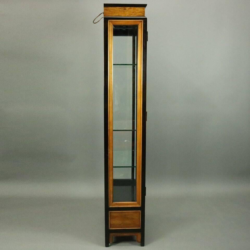 Vintage Asian Japanese style curio cabinet by Century Furniture features burl and ebonized construction with beveled glass side panels and double doors opening to lighted mirror back display compartment with three glass shelves and lower drawer,