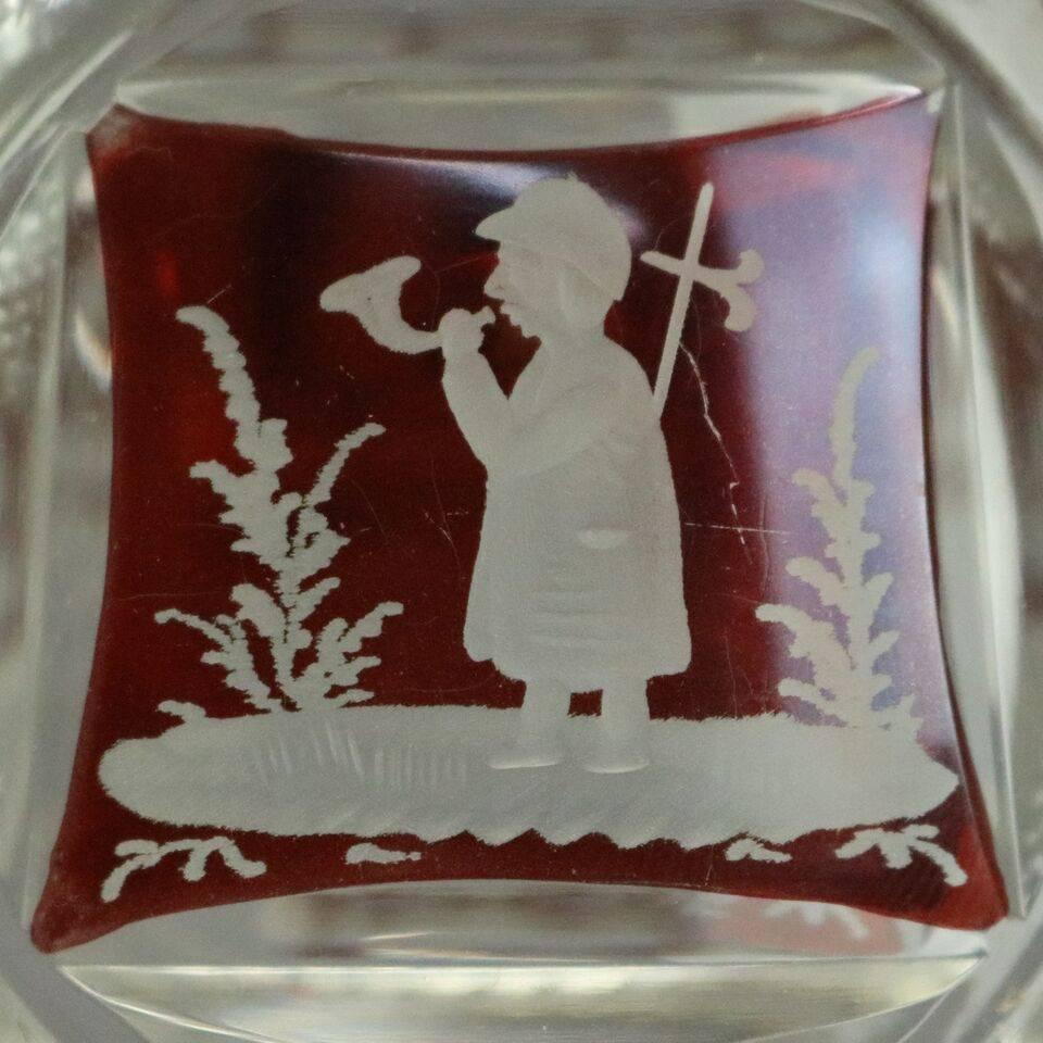 Antique Bohemian style English ruby flash cut decanter features reserves depicting countryside scenes, reeded base and collar, stopper with ruby lined panels, circa 1880.

Measures: 13" height x 5" diameter.