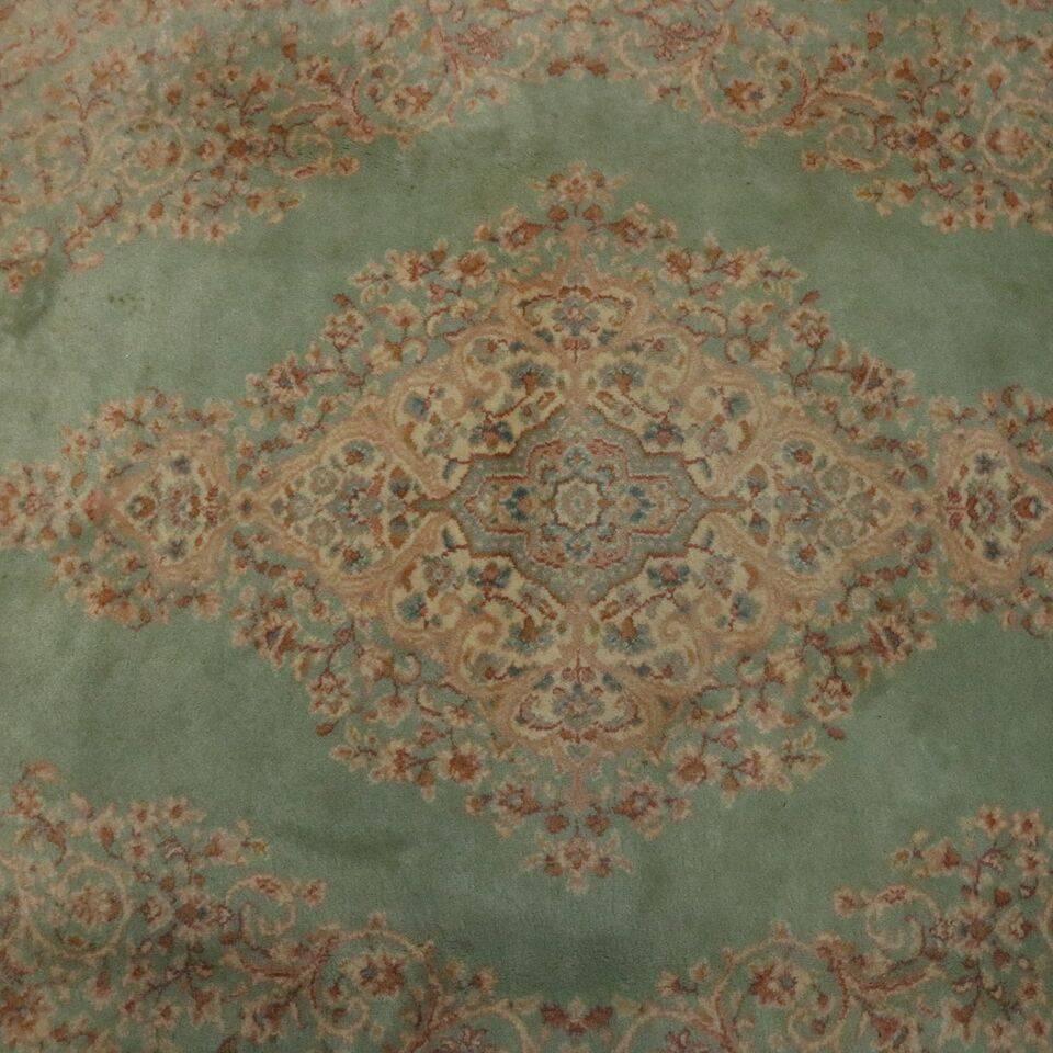 Vintage wool Karastan Kirman pattern #714 features floral motif with central medallion on green ground, en verso original tags, circa 1950.

Measures: 147" x 103".
